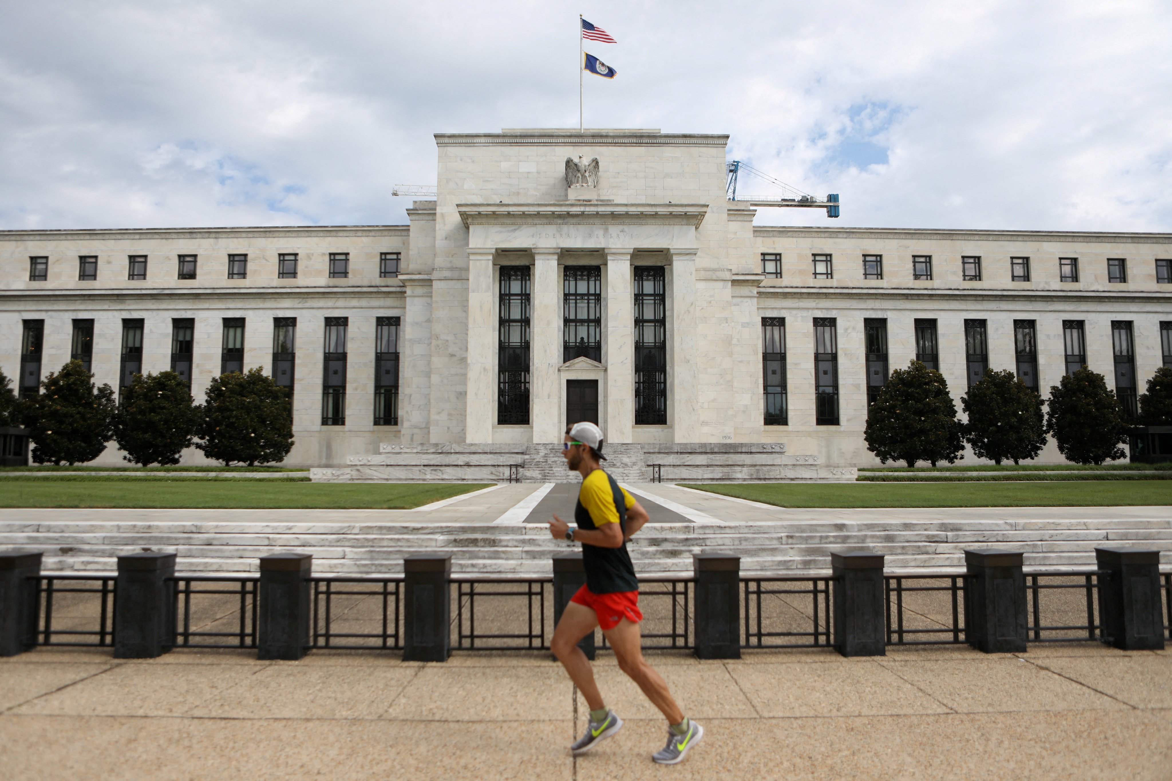 A jogger runs past the Federal Reserve building in Washington on August 22, 2018. American financial dominance not only rests on the US dollar as an invoicing currency for payment, but also as a store of value. Photo: Reuters
