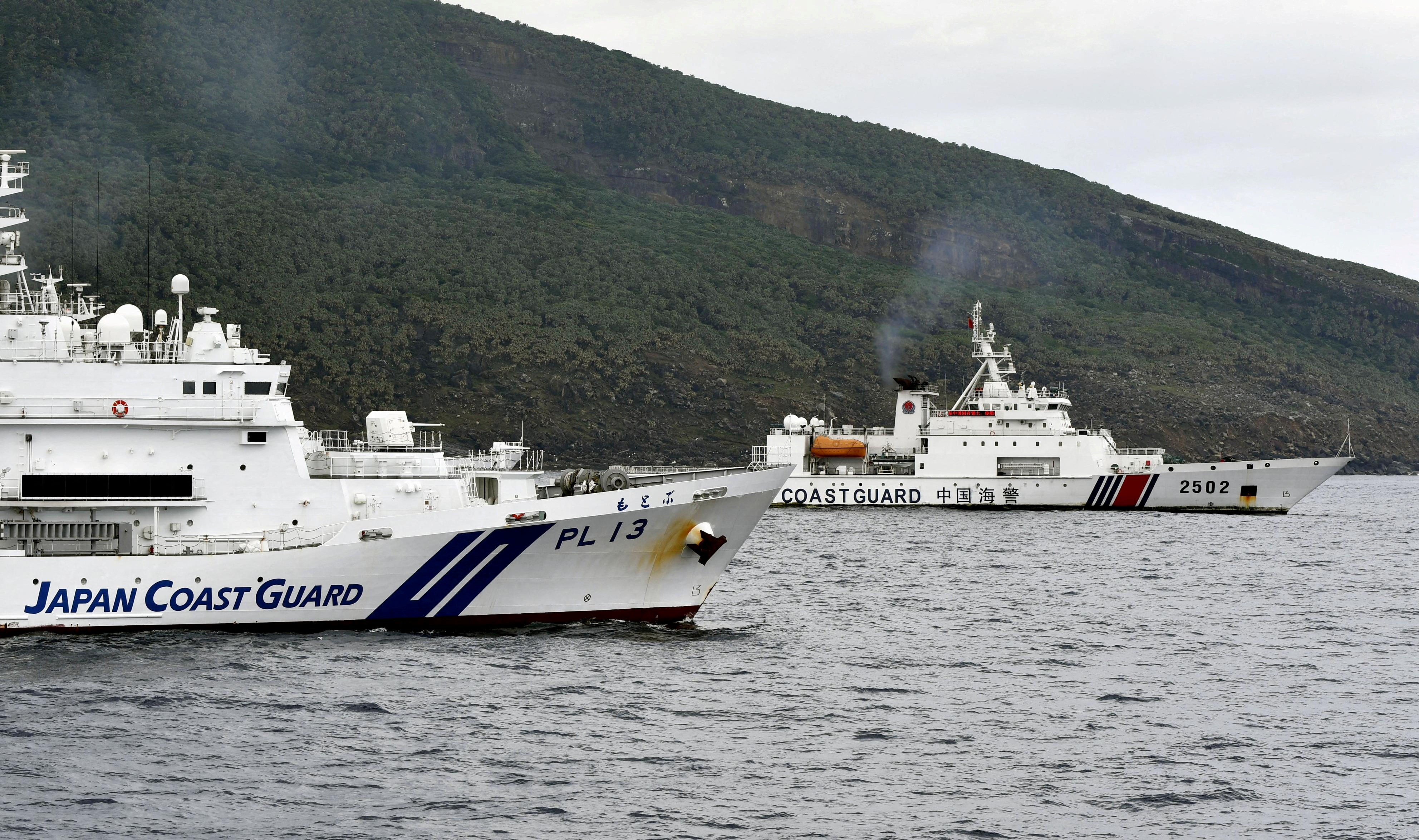 A China coastguard vessel (back) sails near a Japan coastguard vessel off Uotsuri Island, one of a group of disputed islands between the two nations in the East China Sea. Photo: Kyodo