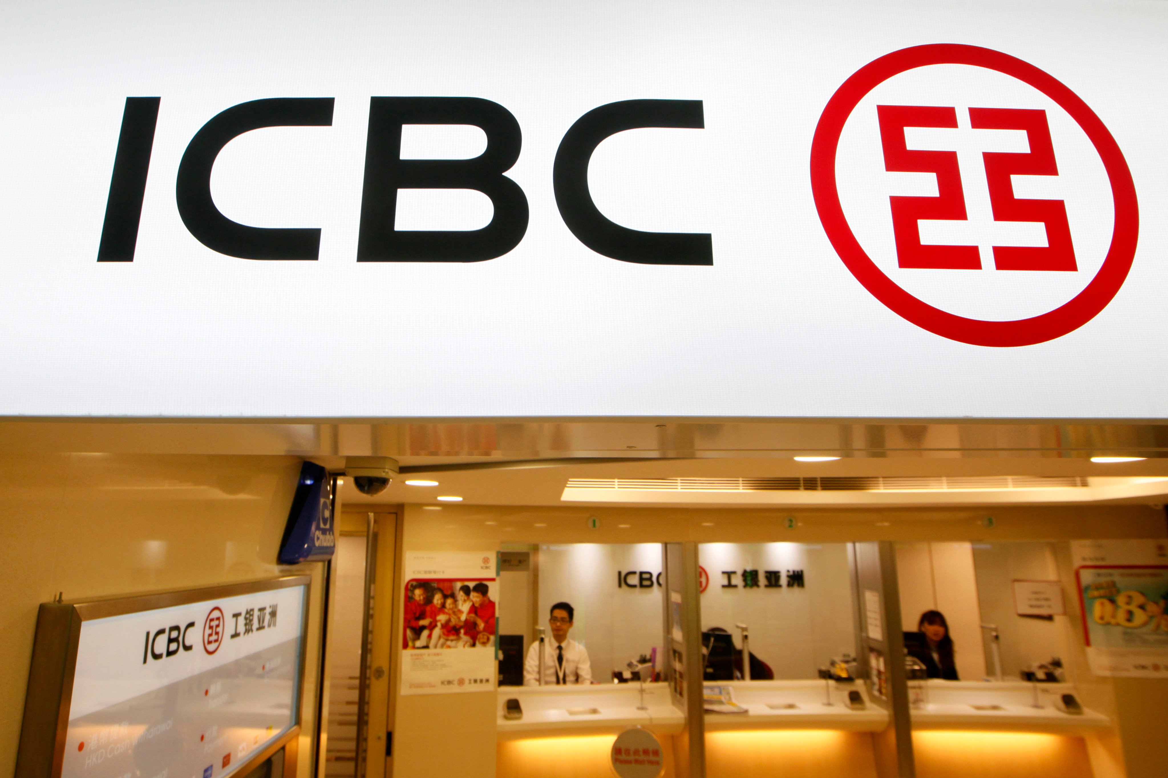 Bank tellers sit in a branch office of the Industrial and Commercial Bank of China (ICBC) in Hong Kong on March 27, 2013. On Thursday, ICBC cut its demand deposit rate by 5 basis points to 0.15 per cent and one-year deposit rate by 10 bps to 1.35 per cent, in a move expected to improve its net interest margin. ICBC’s shares fell 1.4 per cent to HK$4.33. Photo: AP