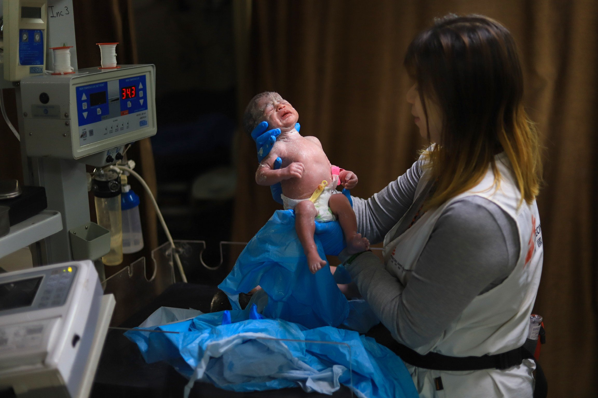 Nurse Krystal So checks on a newborn baby at Gaza’s Nasser Hospital. Photo: Handout