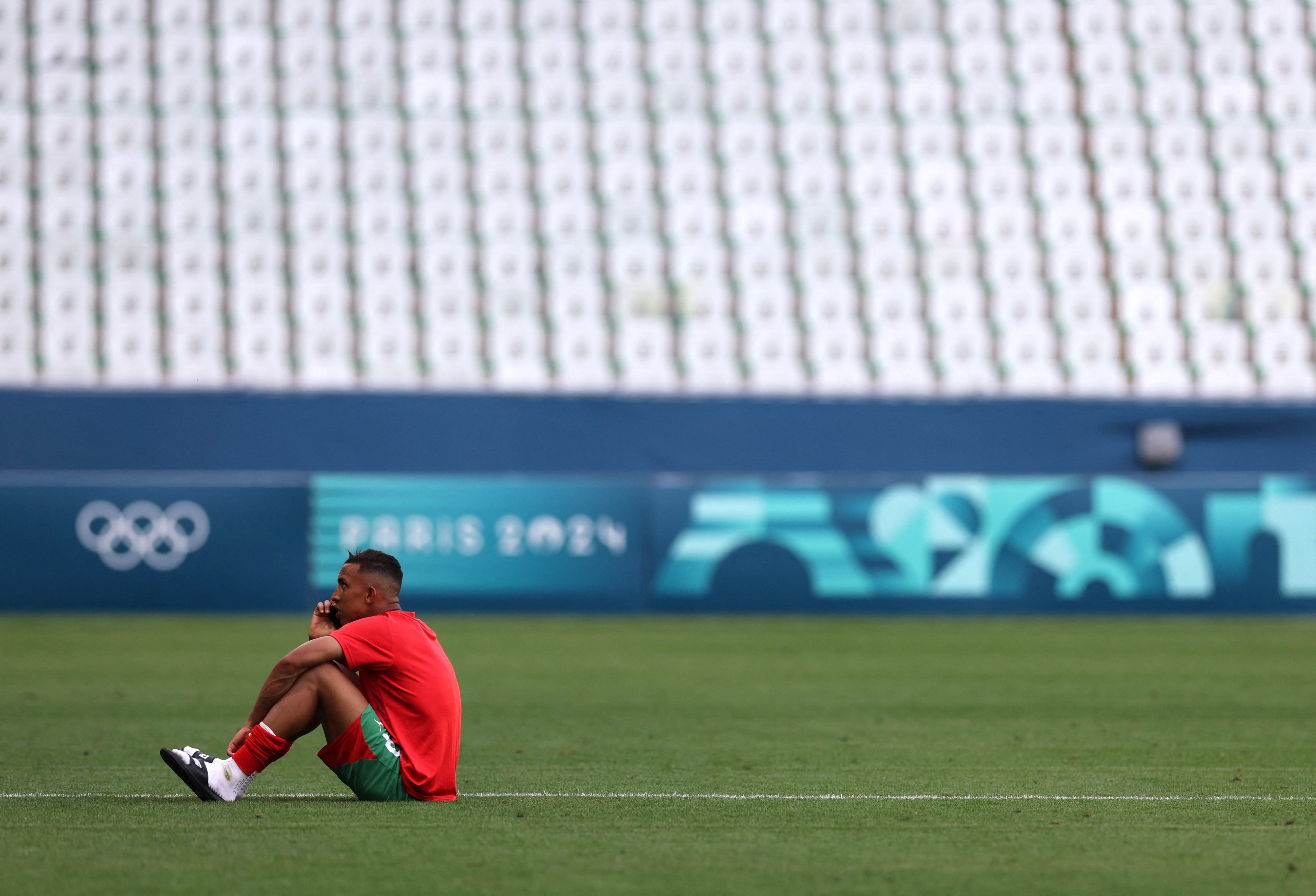 Morocco’s Soufiane Rahimi sits on the pitch at Geoffroy-Guichard Stadium, Saint-Etienne, after his side’s troubled win over Argentina. Photo: Reuters