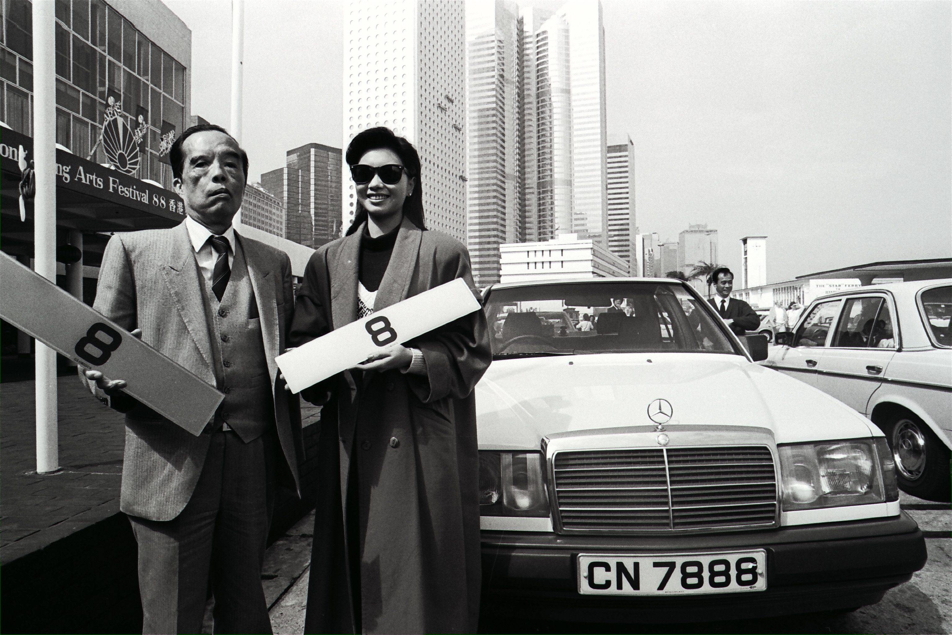 Law Ting-pong, chairman of Laws Fashion Knitters, and Miss Hong Kong Pauline Yeung Po-ling holding up two licence plates numbered 8 for which Law paid HK$5 mllion at auction in February 1988. Photo: SCMP 