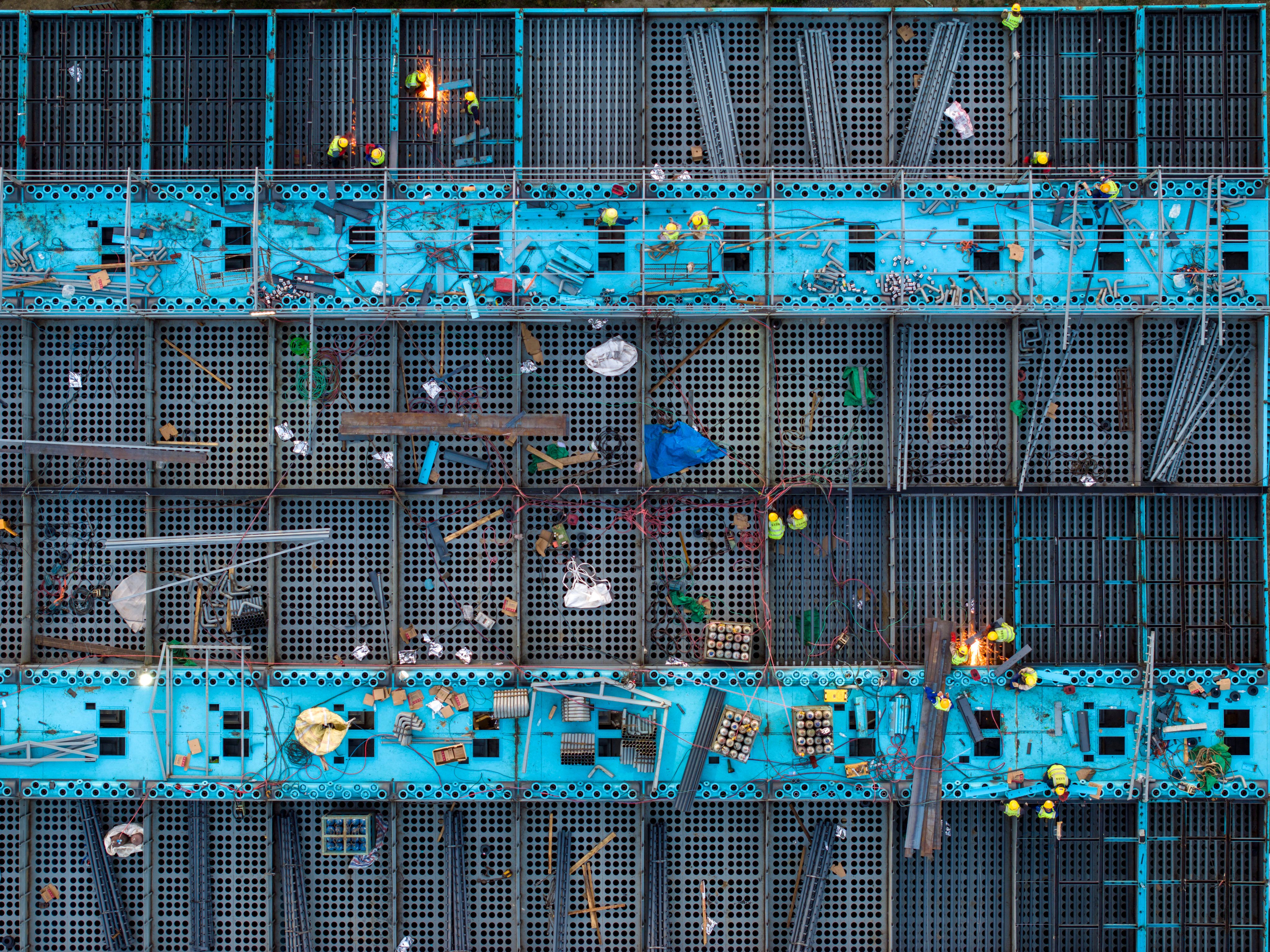 Aerial photo taken on October 29, 2023 shows workers working at the construction site of the electric furnace green energy saving and quality improvement technical transformation project of Jiangsu Shagang Group Huigang Special Steel in Huai ‘an city, Jiangsu Province, China. Photo: Getty Images