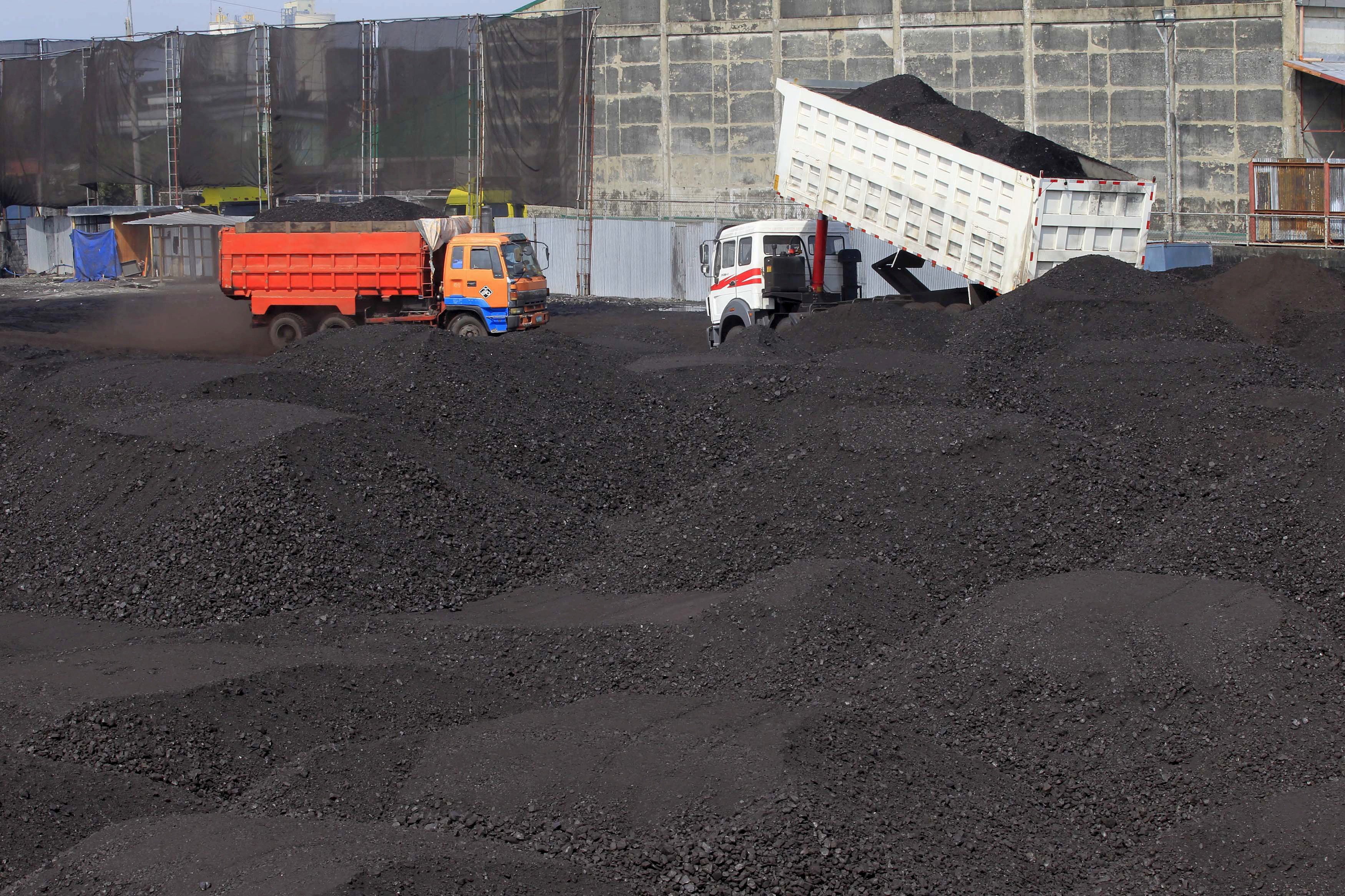 A truck unloads coal in Tondo, Manila. Investments in fossil fuels and other climate-related industries could pose significant risks to banks and insurers in the event of an abrupt transition to meet climate change goals. Photo: Reuters