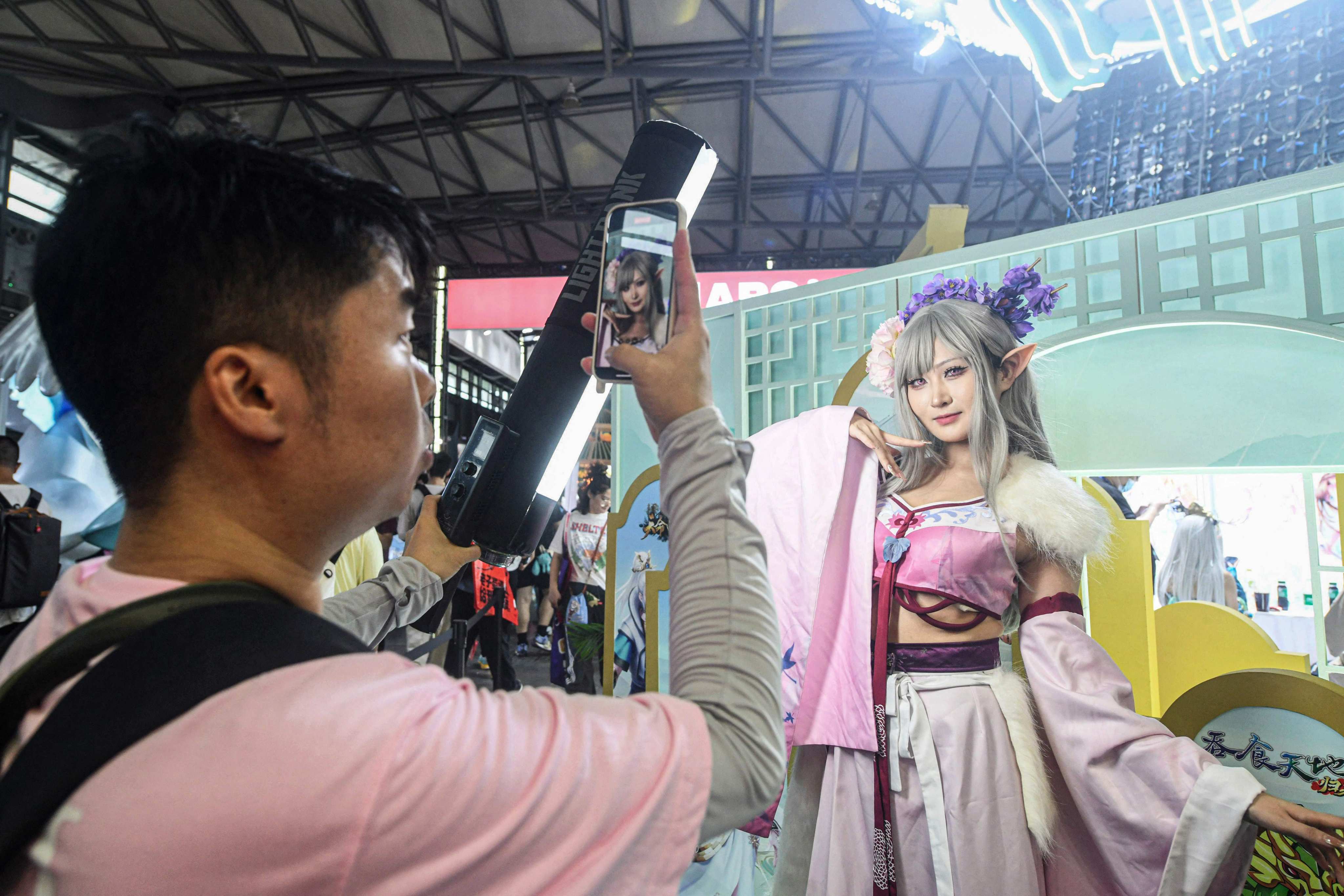 A cosplayer poses for photos at the opening of the annual ChinaJoy digital entertainment expo in Shanghai on Friday. Photo: AFP