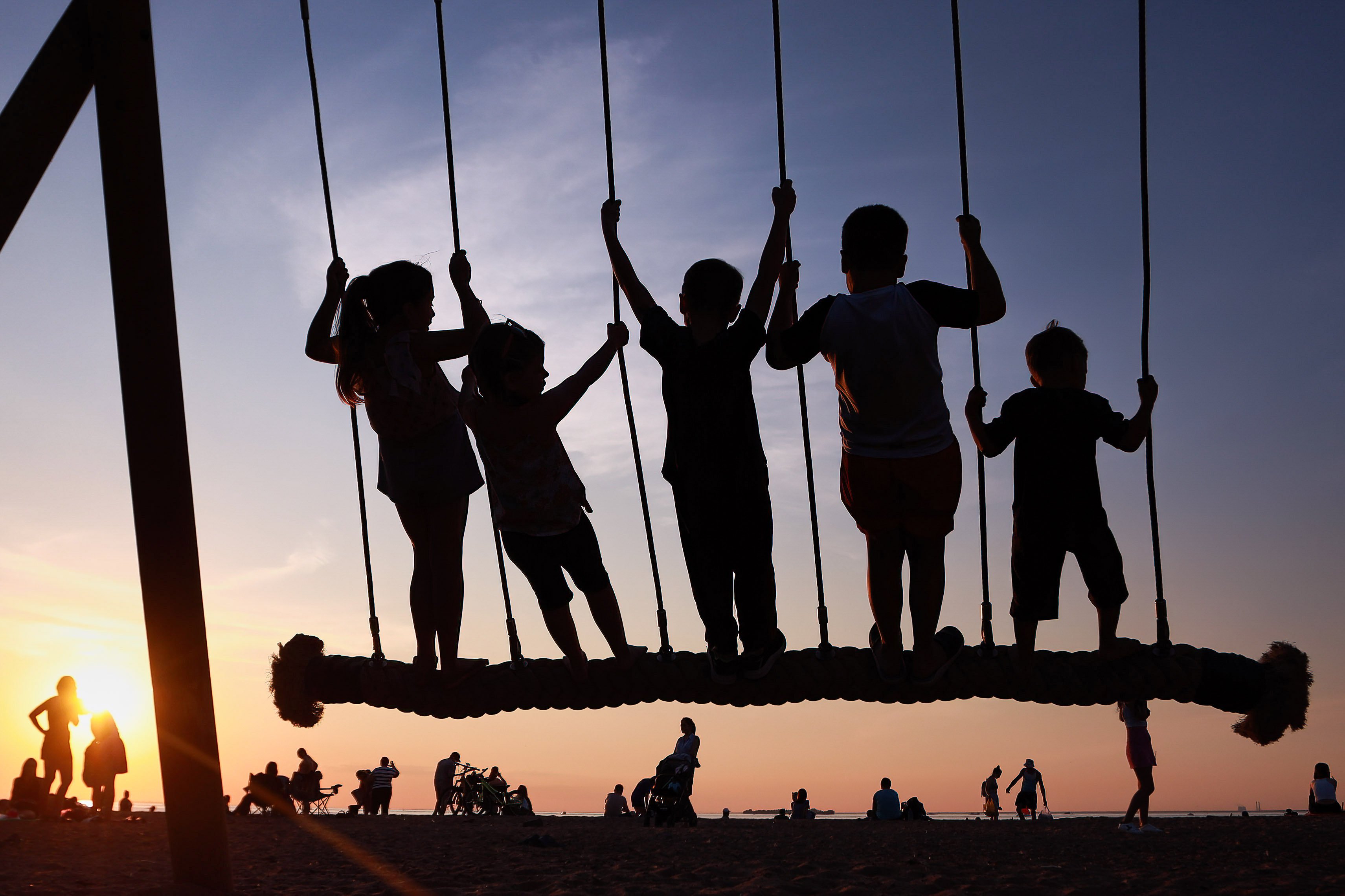 Children swing at Pearl Beach, in St Petersburg, Russia, on Thursday. Photo: dpa