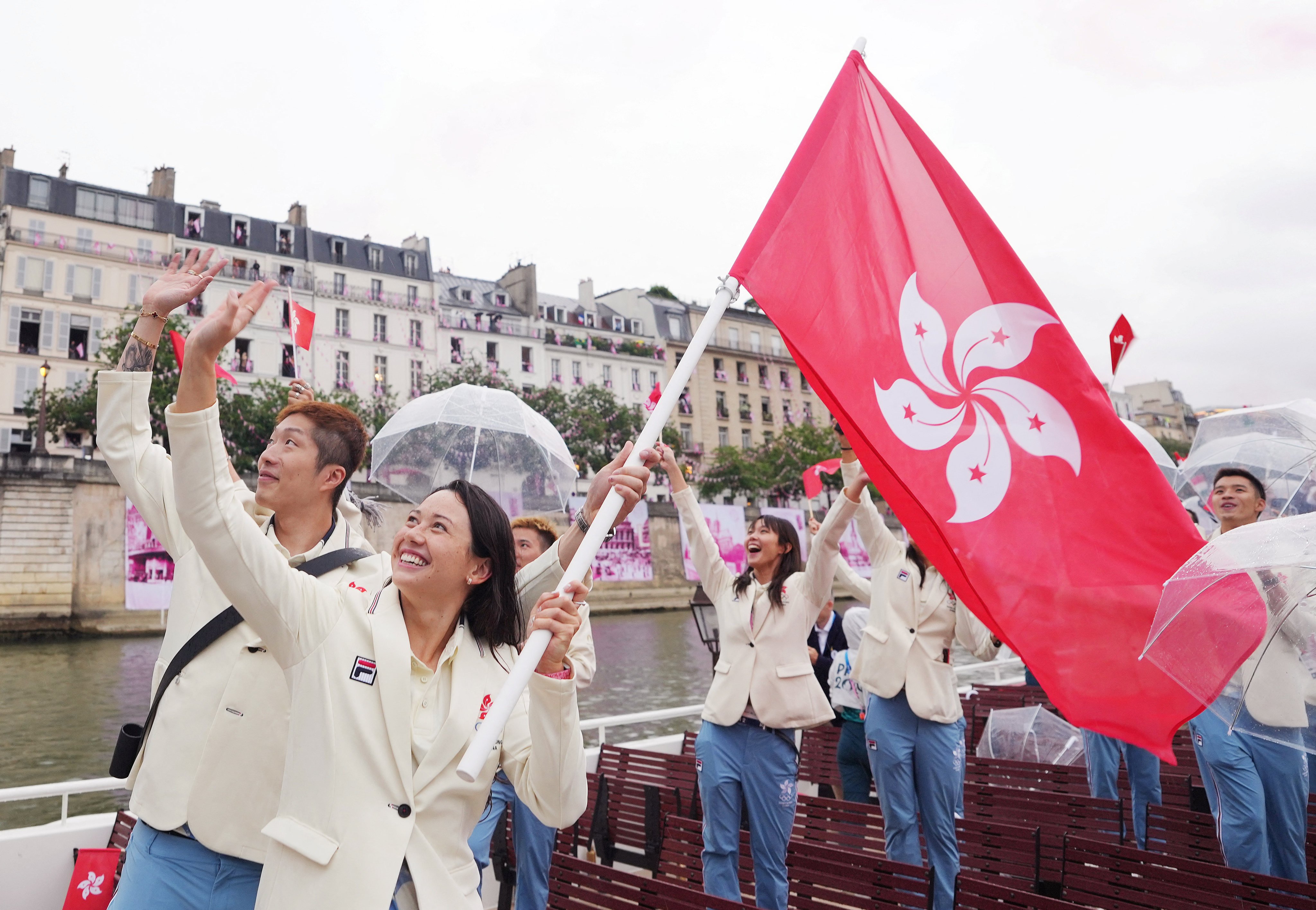 Hong Kong flag bearers Cheung Ka-long (left) and Siobhan Haughey wave to spectators during the opening ceremony for the 2024 Paris Olympic Games. Photo: Reuters