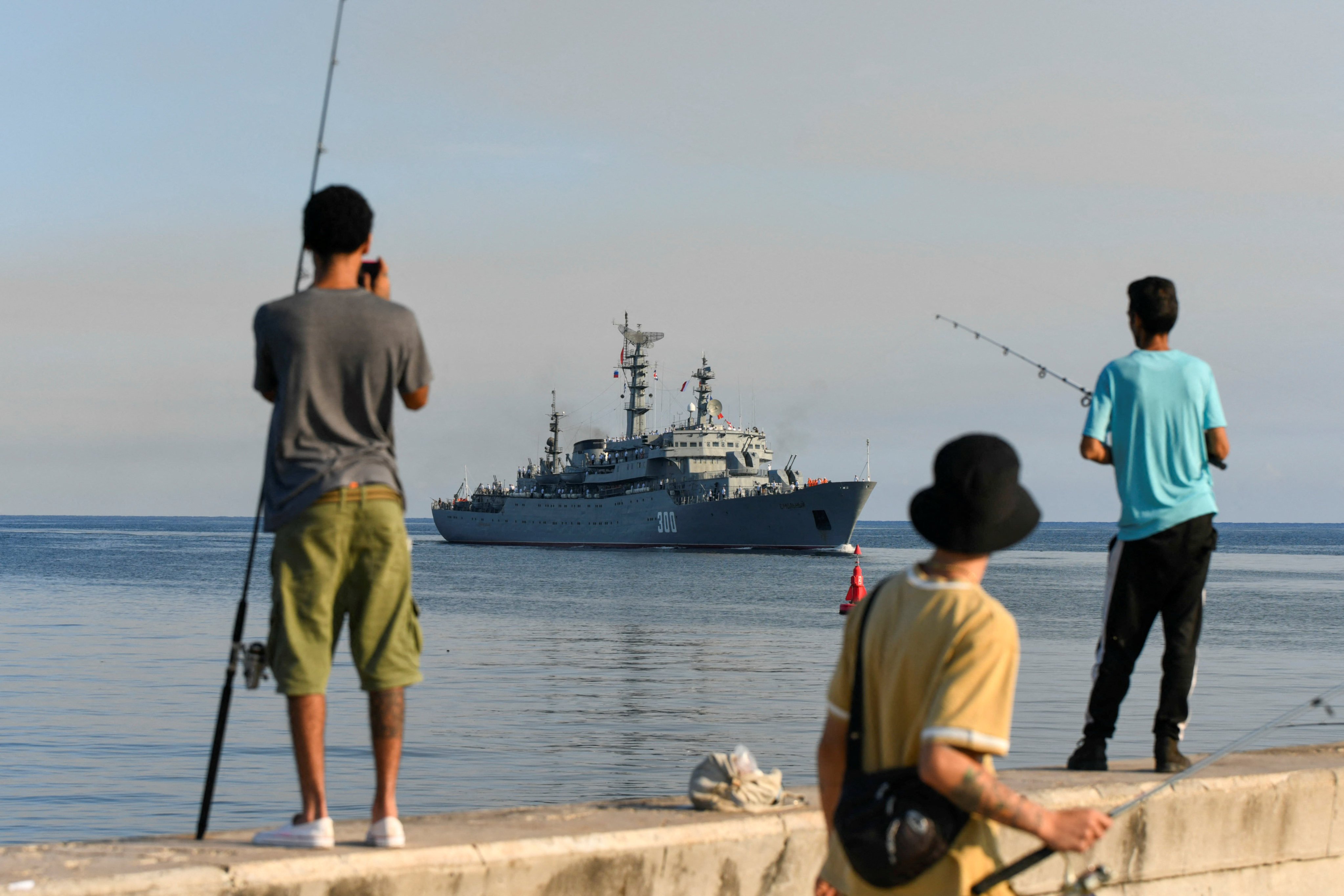 Fishermen watch as a ship from Russia’s Baltic Fleet arrives in Havana on Saturday. Photo: Reuters