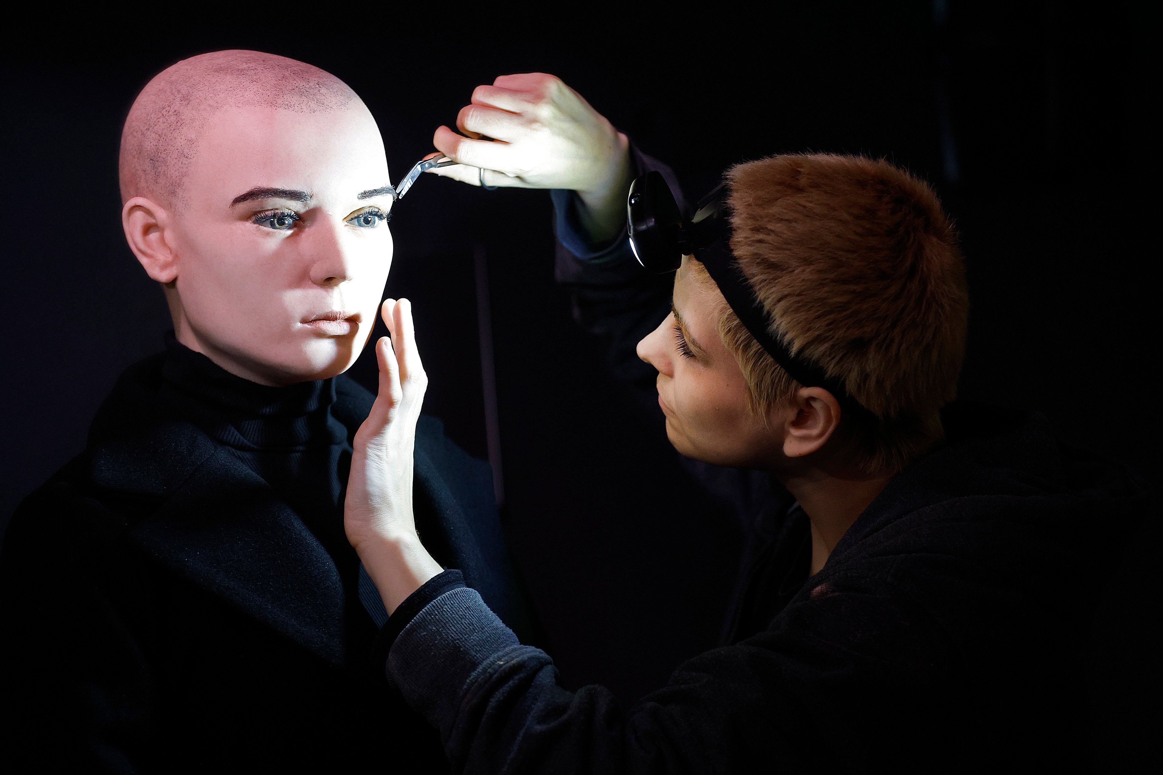 Artistic coordinator Mel Creek applies the finishing touches to a wax figure of the late singer Sinead O’Connor at the National Wax Museum Plus in Dublin’. The waxwork was criticised for looking nothing like the singer, and swiftly withdrawn from display. Photo: Julien Behal via AP