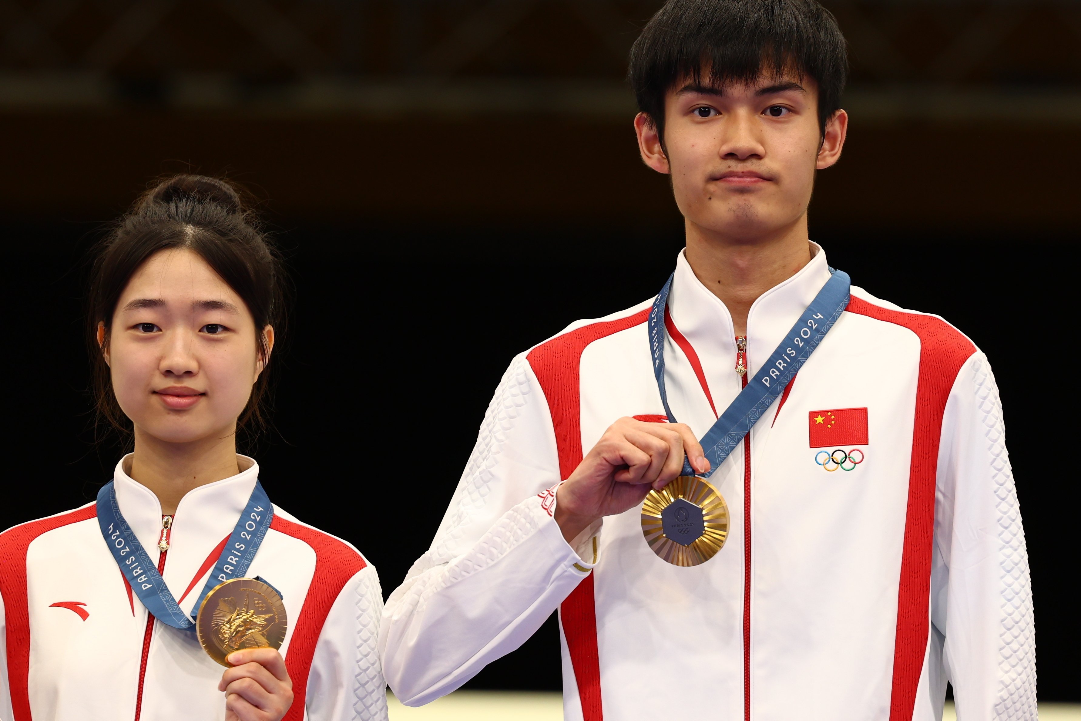 Gold medalists Huang Yuting and Sheng Lihao pose with their medals after winning the mixed team 10m air rifle event. Photo: EPA-EFE