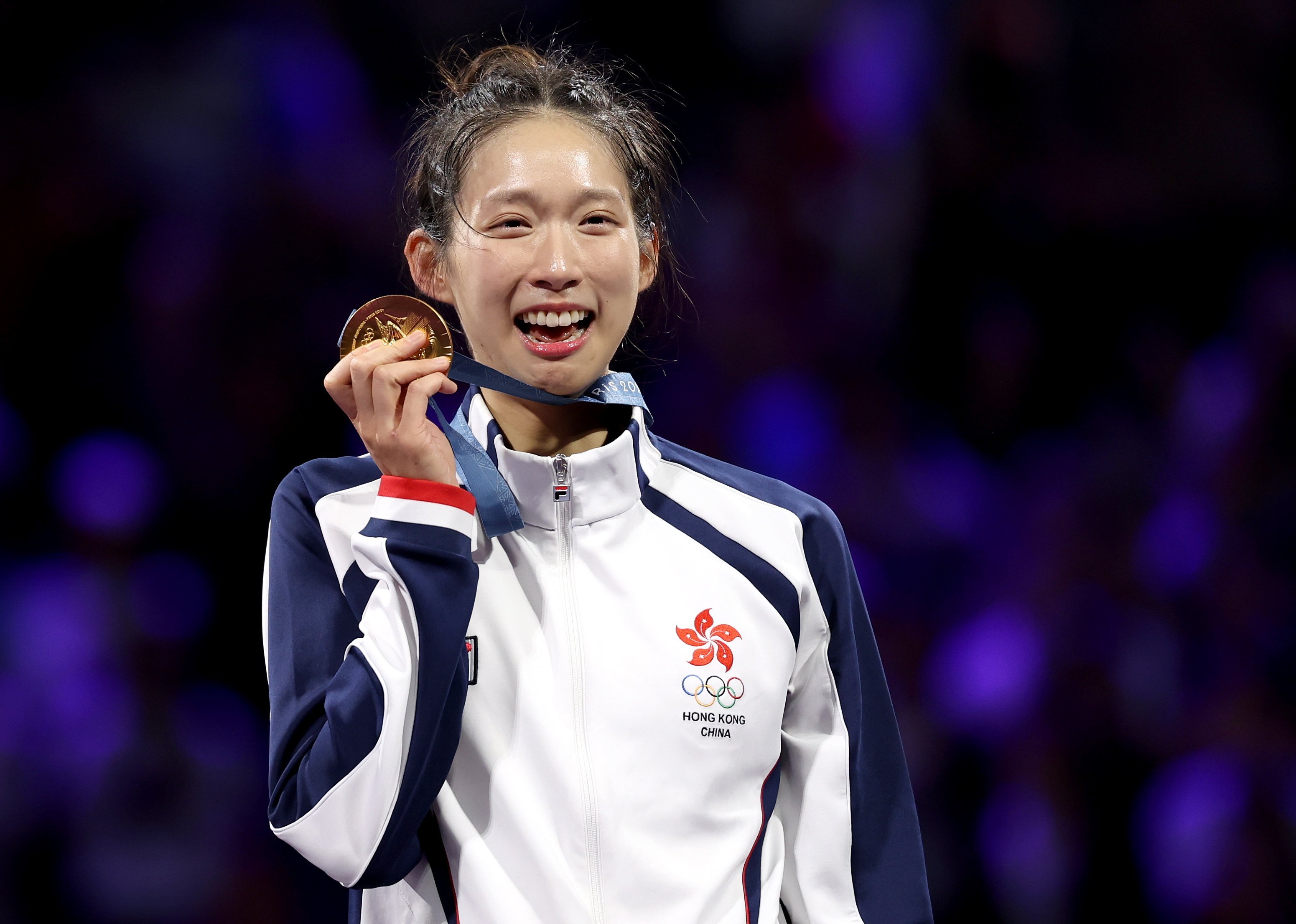 Vivian Kong poses with her gold medal after winning the women’s individual epee at the Paris Olympics. Photo: EPA-EFE