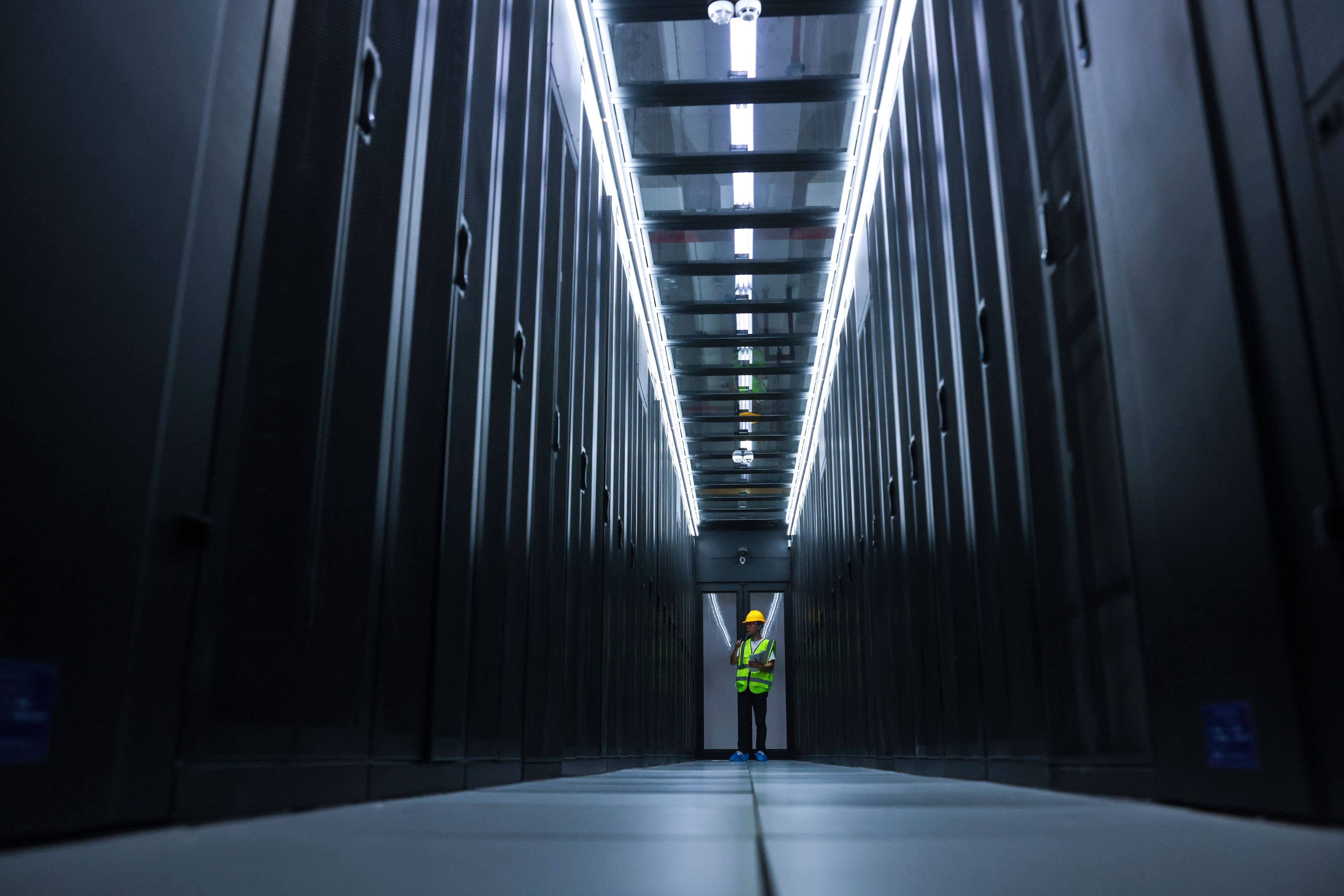 A China Mobile employee checks equipment at the company’s data centre in southwest Guizhou province. Photo: Xinhua