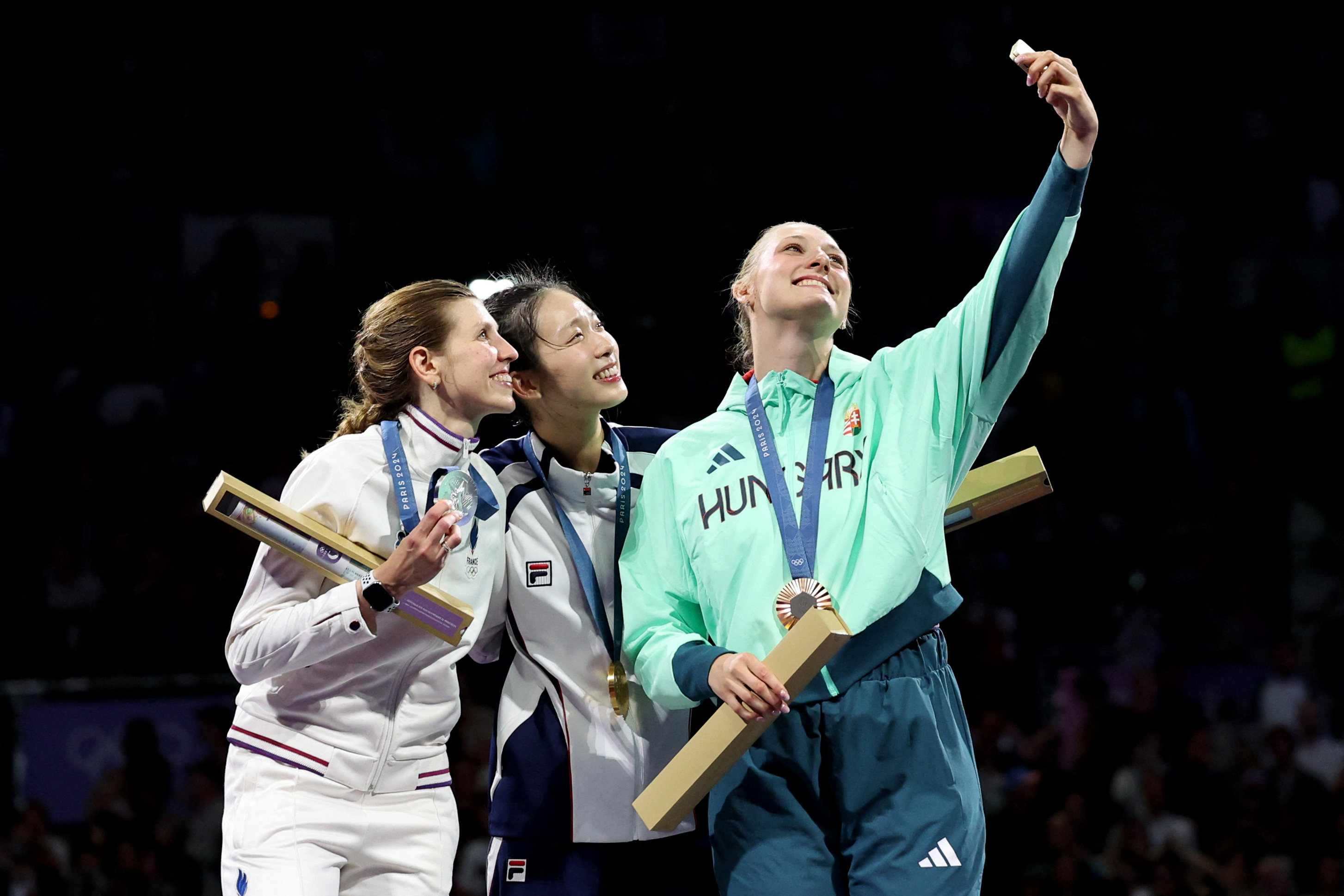 Vivian Kong (centre) celebrates her gold medal win on the podium with France’s silver medallist Auriane Mallo-Breton (left) and Hungary’s Eszter Muhari (right), who won bronze. Photo: Reuters