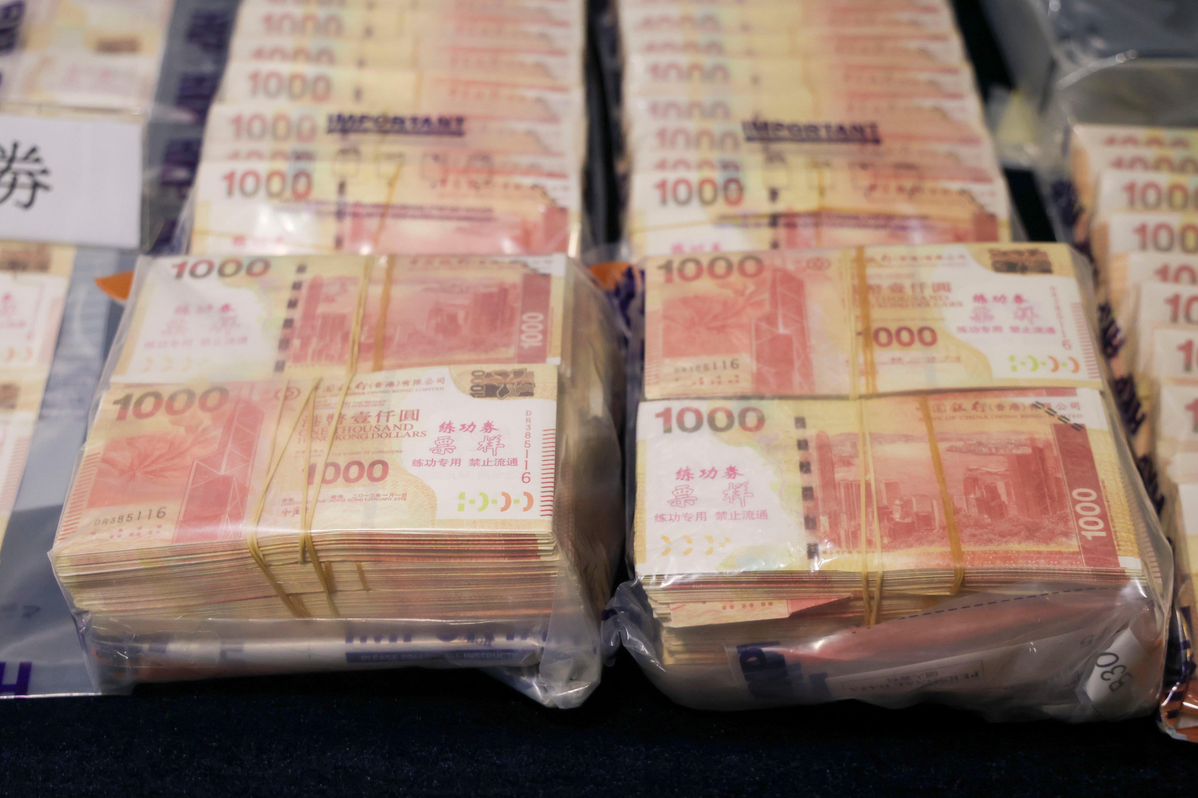 Stacks of bogus bank notes displayed as evidence. Police say the masterminds impersonated a well-known cryptocurrency investor. Photo: Jelly Tse