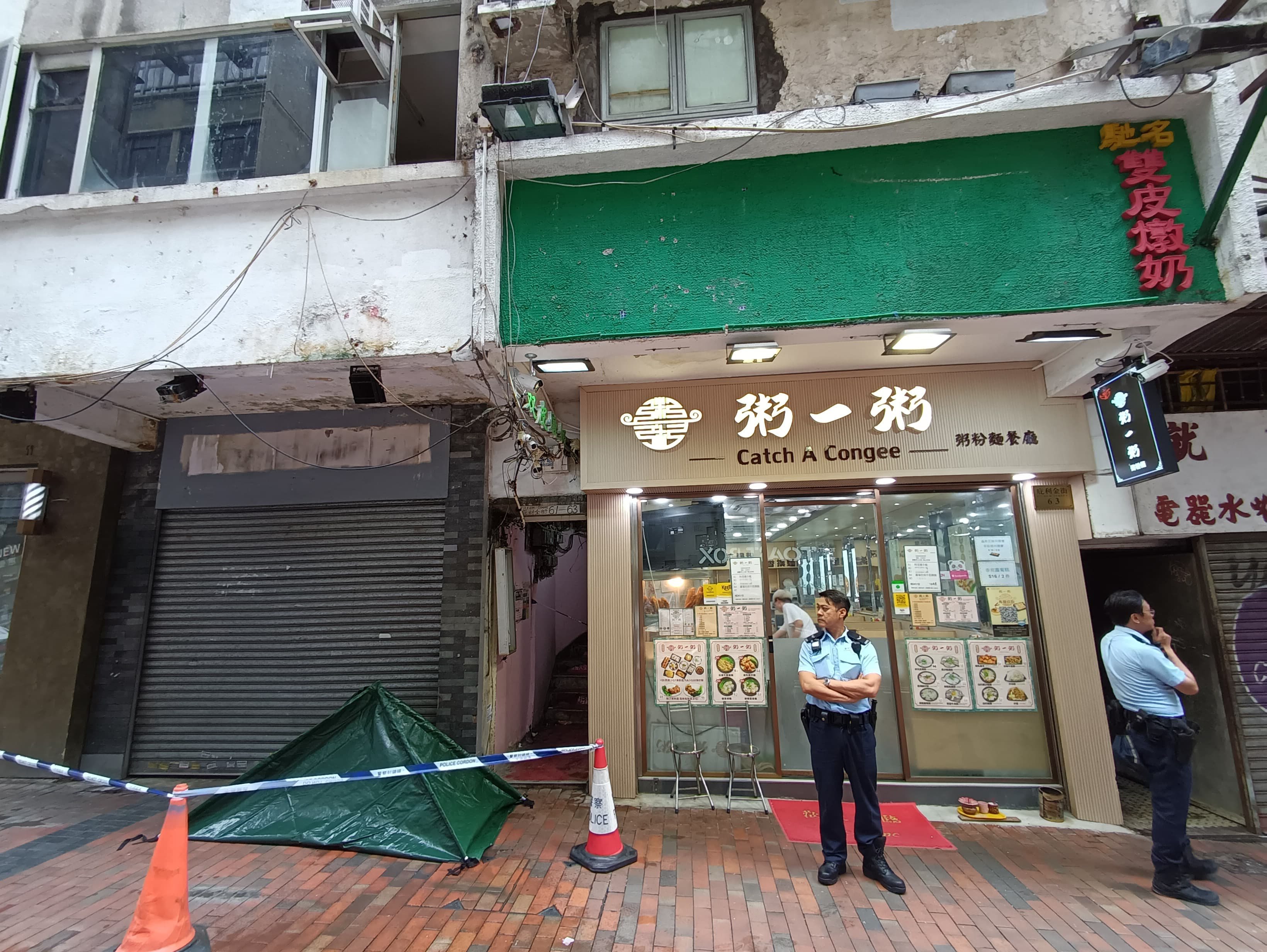 Police stand guard near where a man was found dead in Bowring Street in Jordan in the early hours of Sunday. Photo: Handout