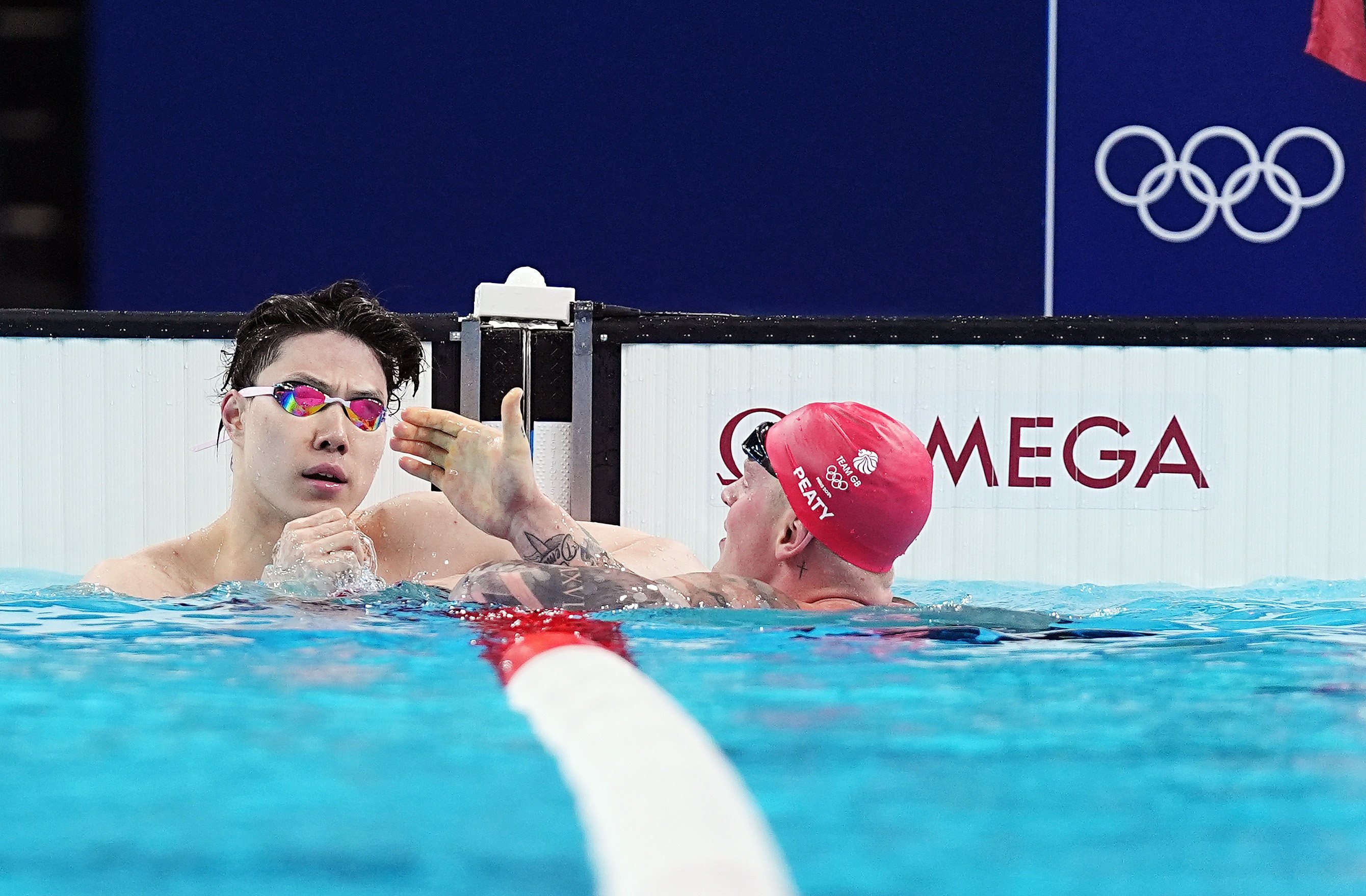 Qin Haiyang (left), who finished seventh in the 100m breaststroke final, accused doping testers of being part of a “European and American” plot to unsettle China’s team. Photo: Xinhua