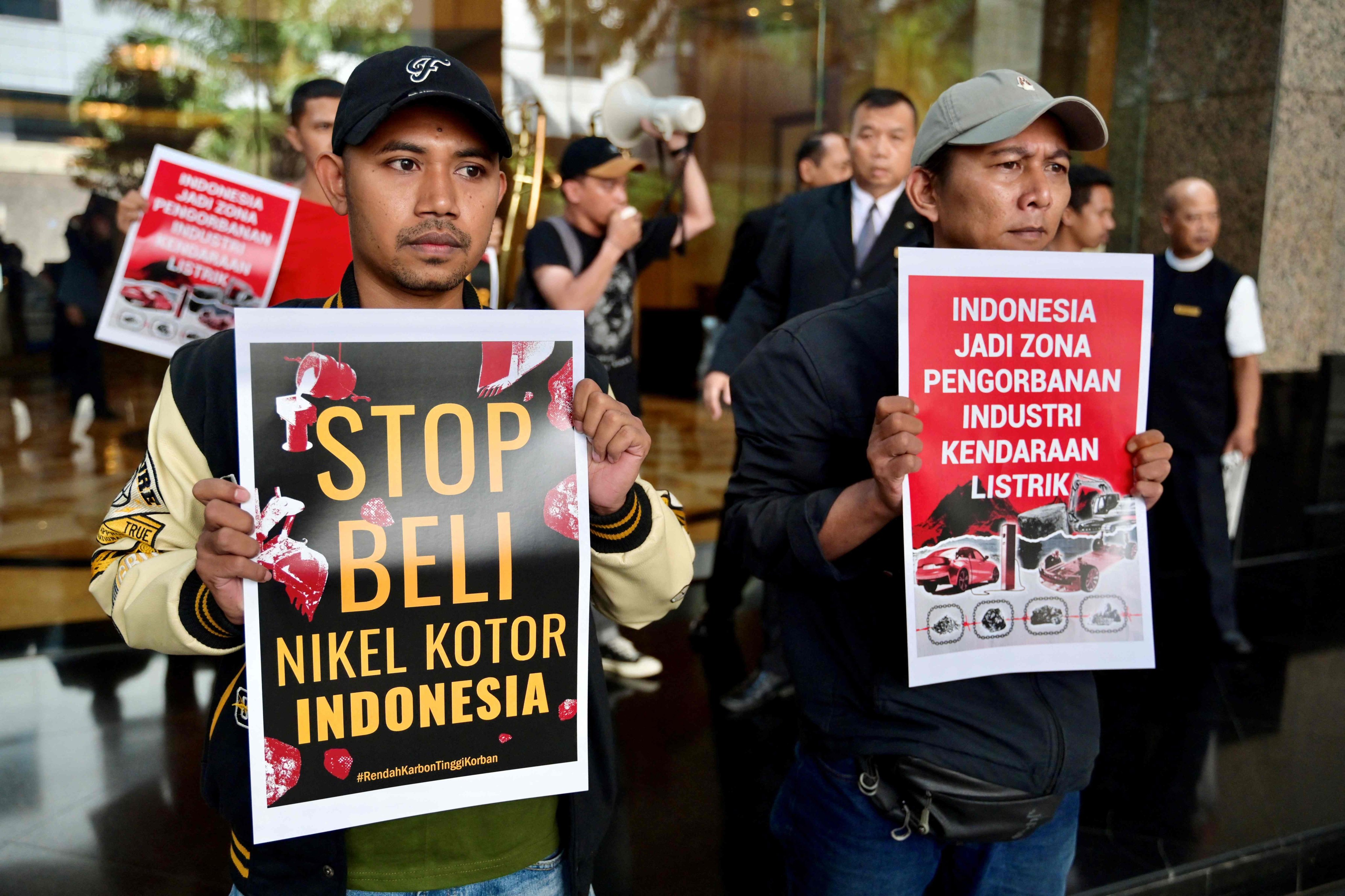 Activists display posters reading “stop buying Indonesia’s dirty nickel” and “Indonesia has become a sacrifice zone for the electric vehicle industry” in Jakarta on June 13. Australia’s waste management practices, mine site rehabilitation and indigenous community engagement have often been cited as global examples of sustainable mining. Photo: AFP