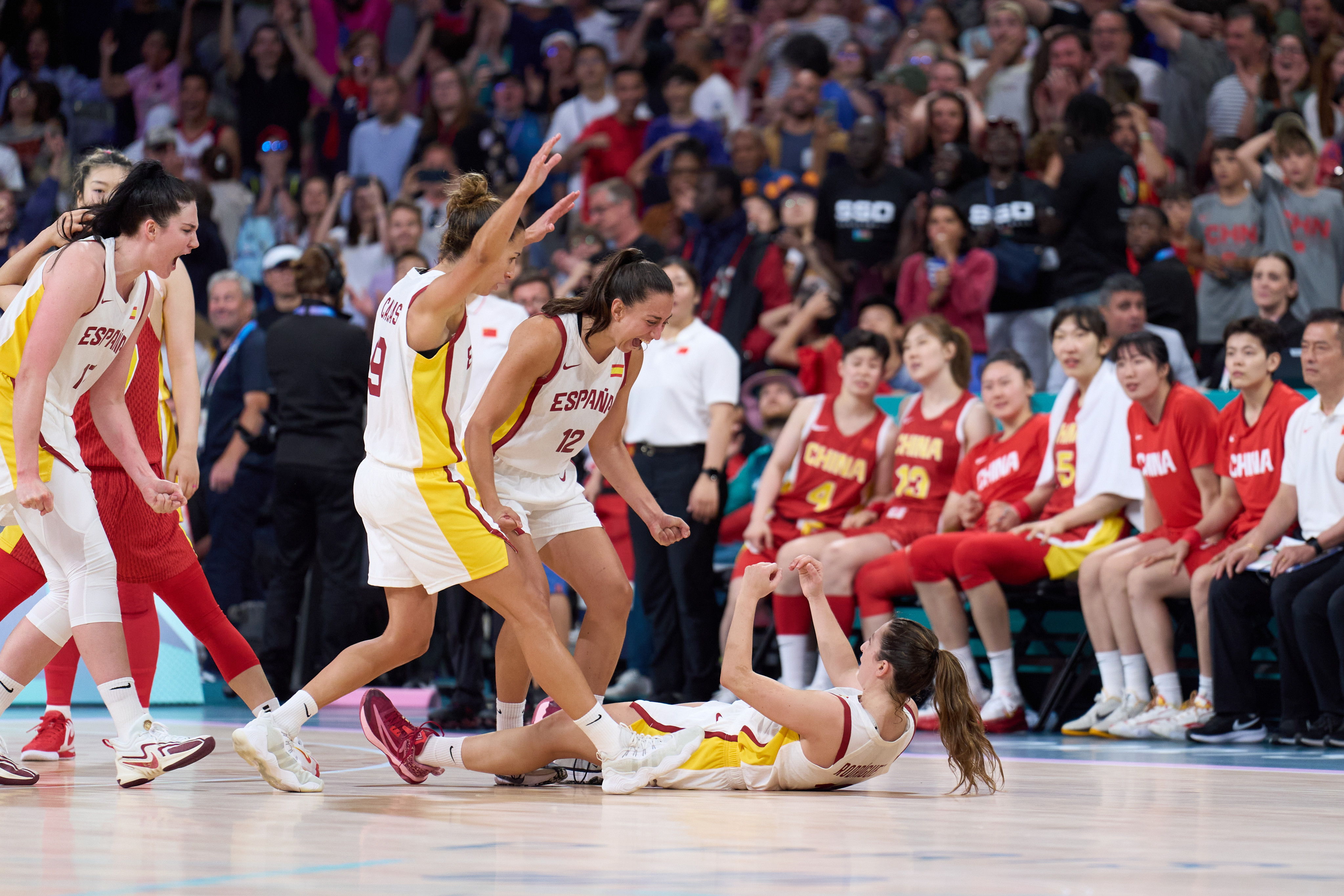 Spain’s players celebrate as China’s bench looks dejected during their tense clash at the Paris Olympic Games. Photo: Xinhua