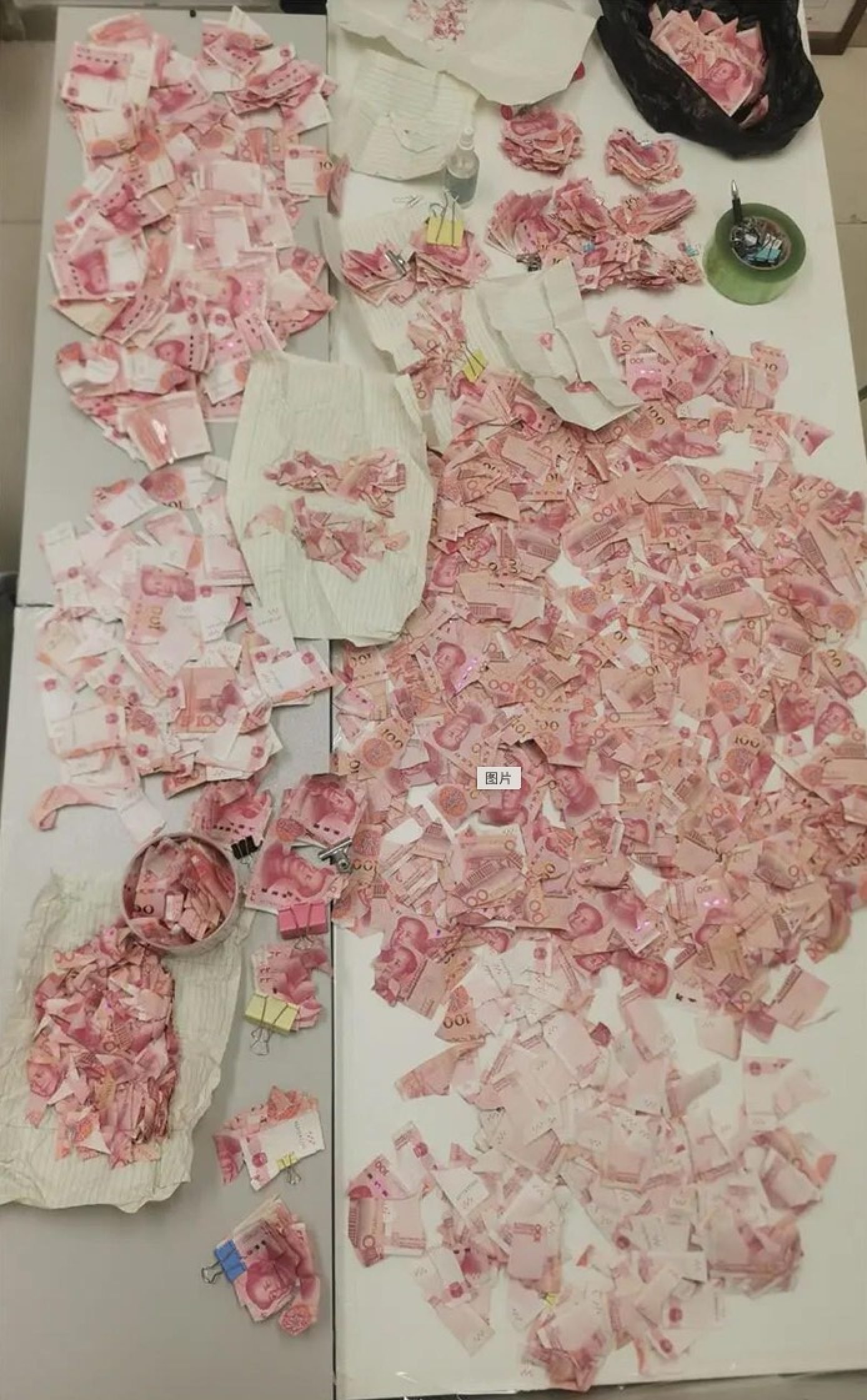 Cash puzzle: bank staff spent weeks restoring US$4,500 worth of banknotes. Photo: Baidu