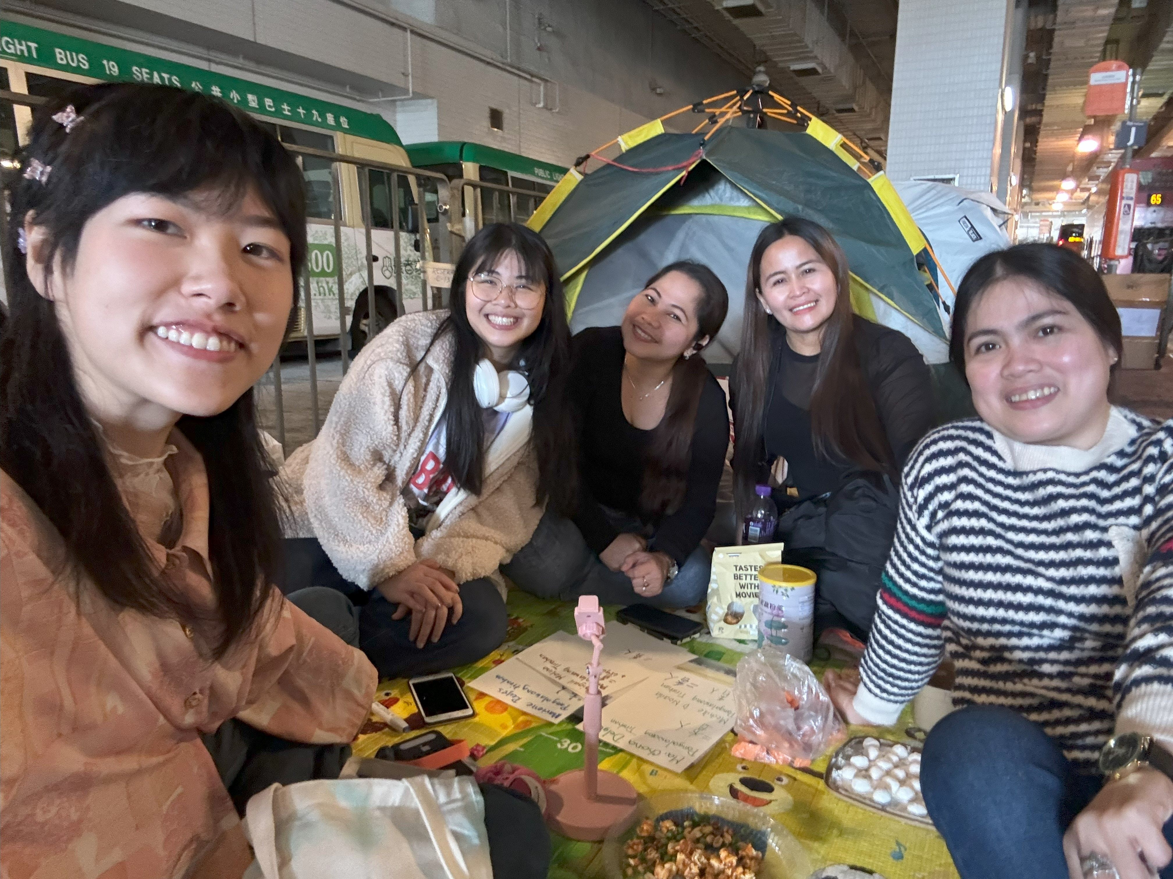 Tiff Chun, the main coordinator of Second Home, conducts street interviews with some of the city’s migrant workers. Photo: Handout