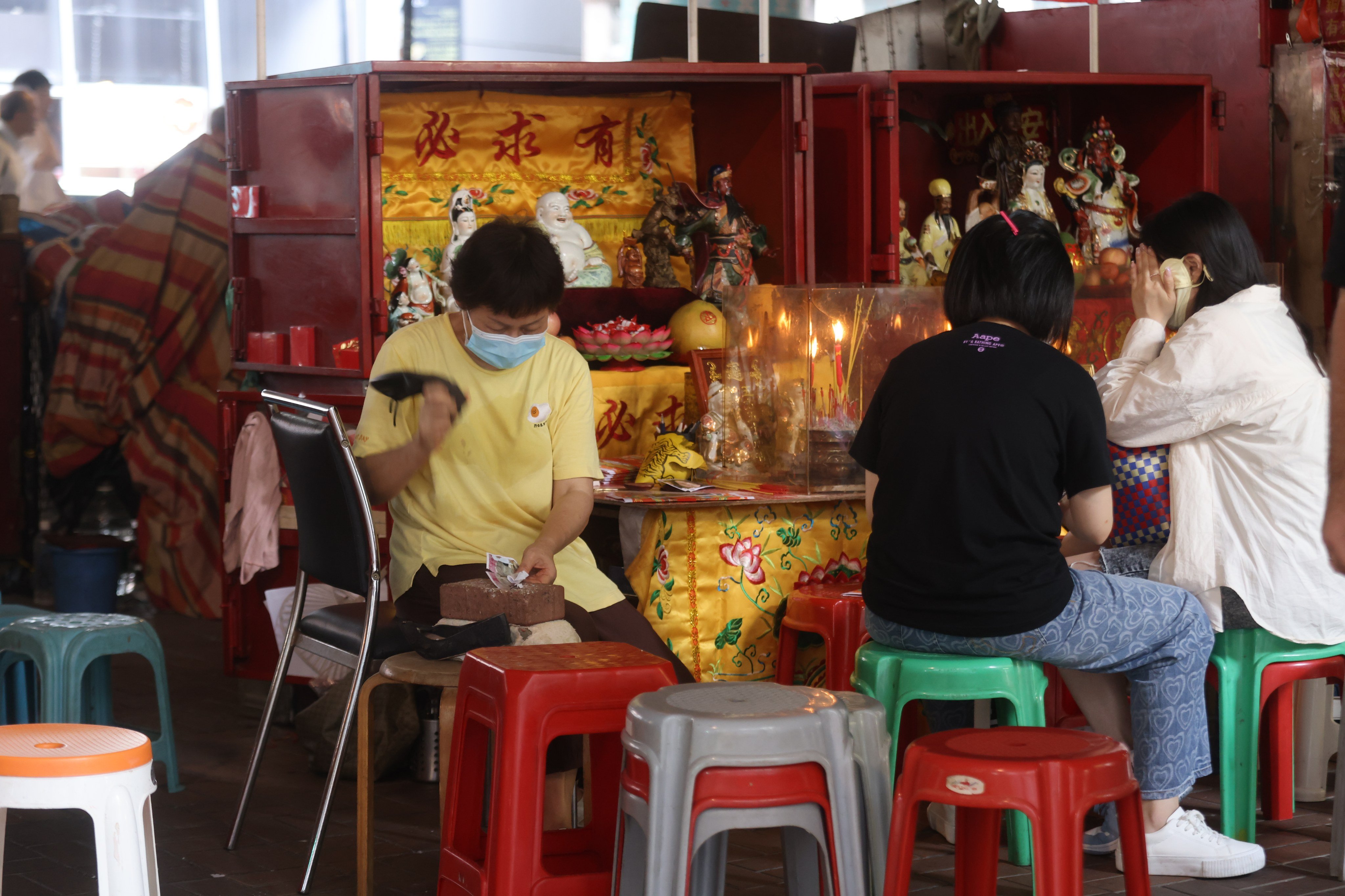 A practitioner performs a villain-hitting ritual in Causeway Bay, Hong Kong. Fortune-tellers break down the practice and explain its history. Photo: Jonathan Wong