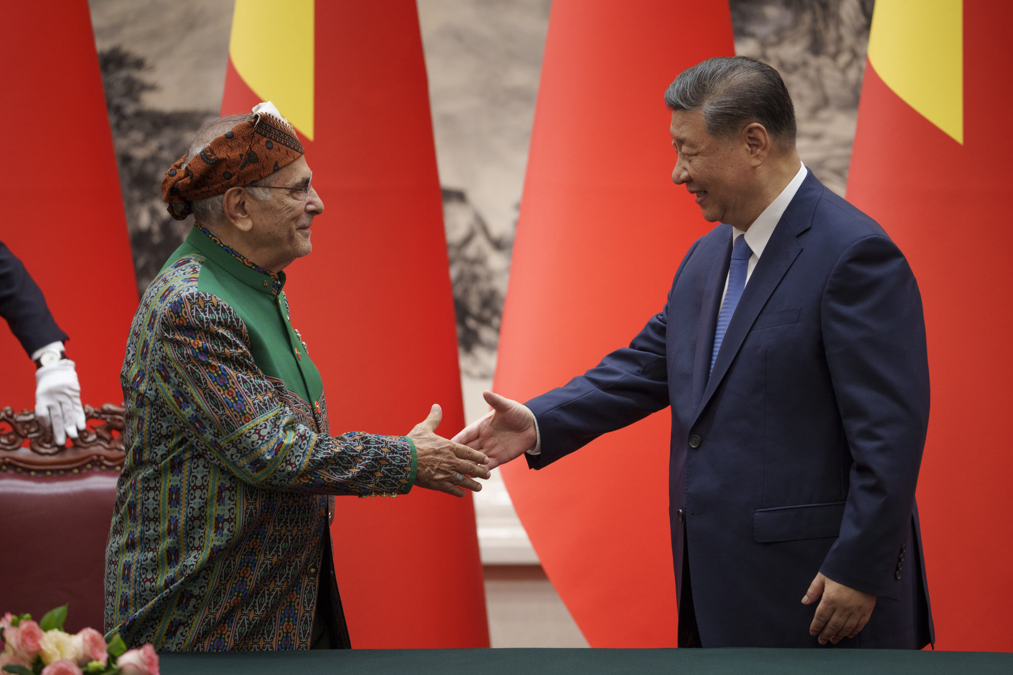 Ramos-Horta and Xi shake hands after the two sides agreed to step up cooperation. Photo: AP