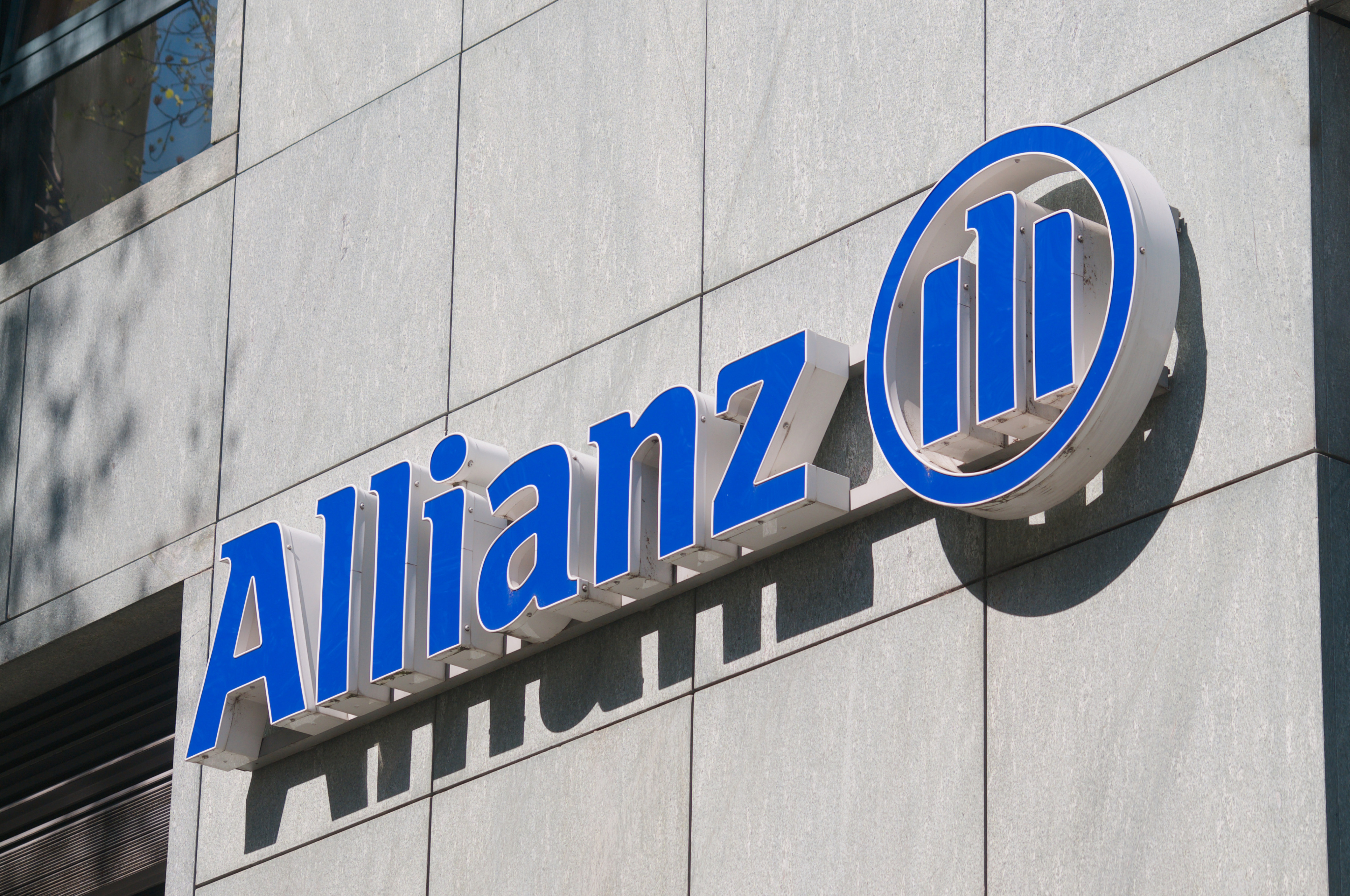 Allianz company sign hanging on a building in Lugano. Photo: Shutterstock