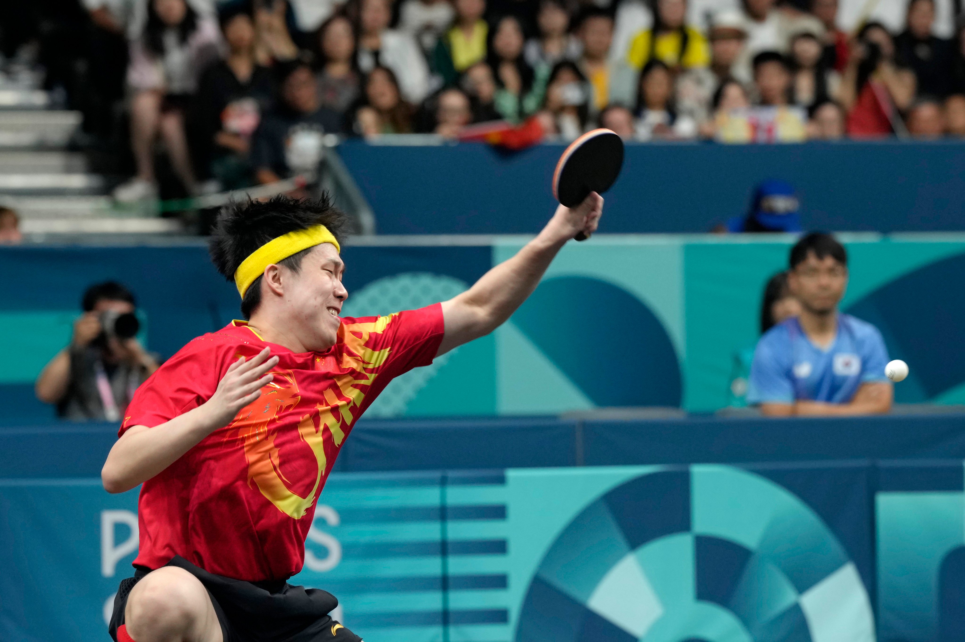 China’s Wang Chuqin had his bat damaged after winning gold in the table tennis mixed doubles. Photo: AP