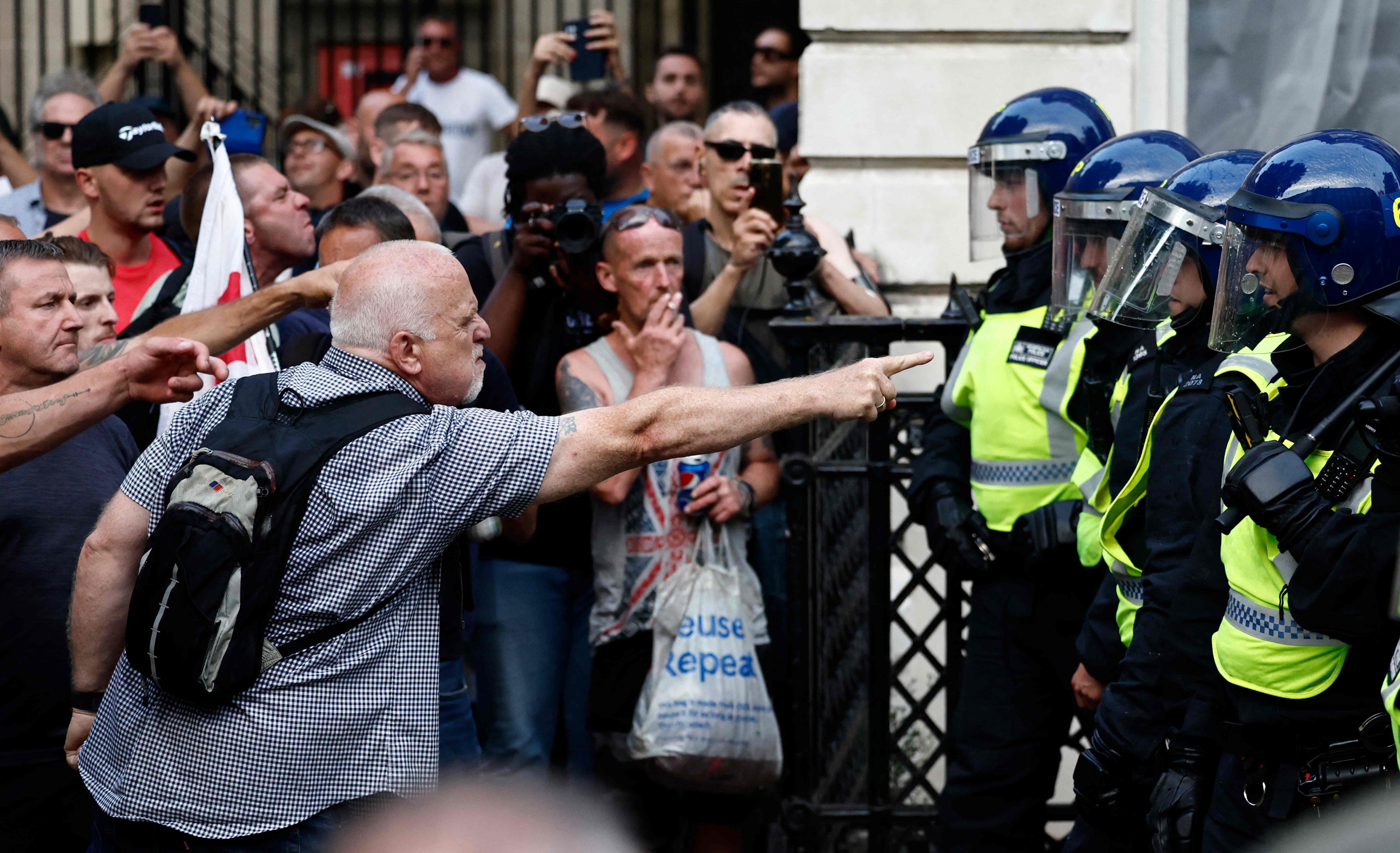 Protestors remonstrate with police during the ‘Enough is Enough’ demonstration outside the entrance to 10 Downing Street in London on Wednesday, held in reaction the government’s response to the fatal stabbings of children in Southport. Photo: AFP