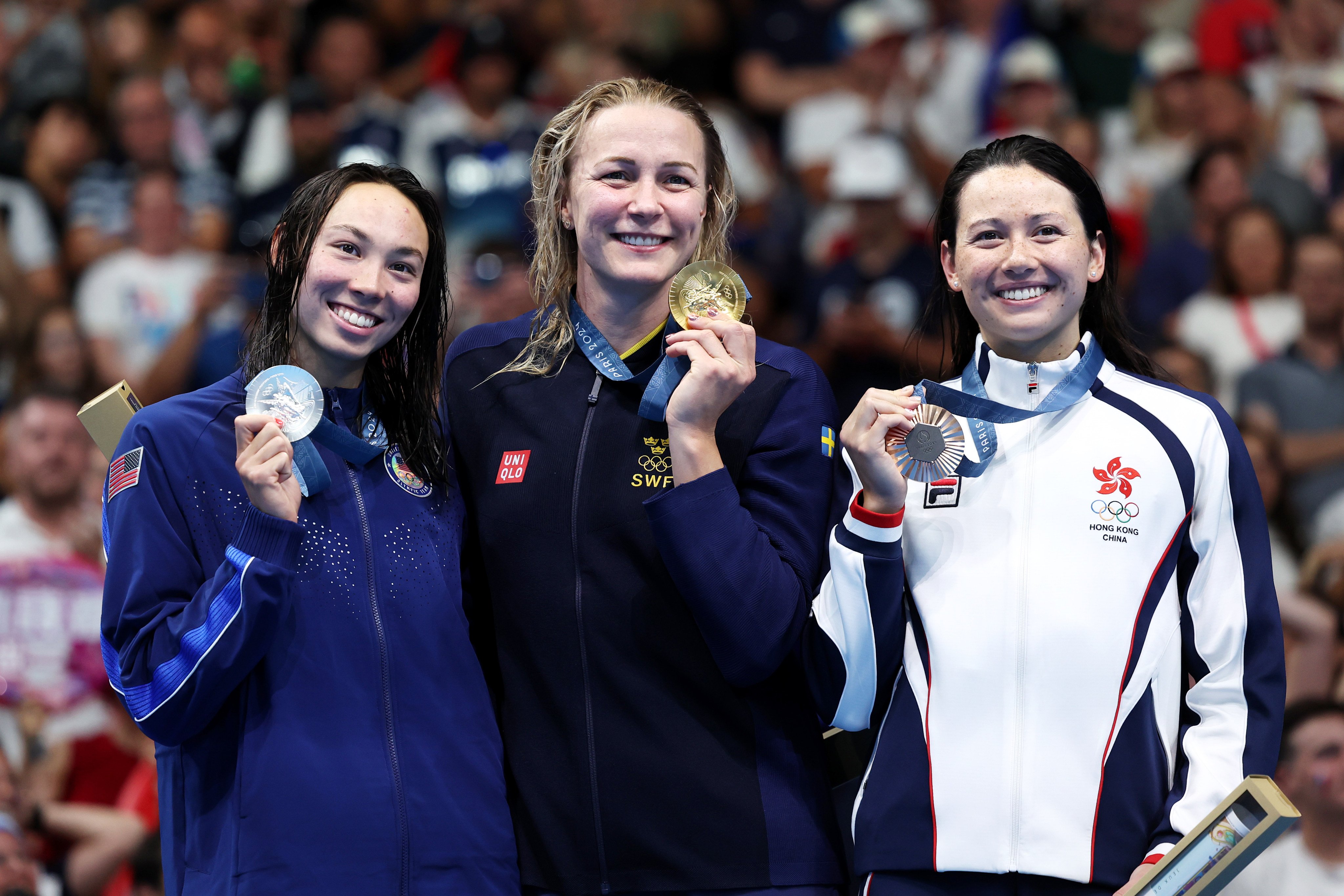 Gold medallist Sarah Sjostrom (centre), is flanked by silver medallist Torri Huske (left) and bronze medallist Siobhan Haughey after the women’s 100m freestyle final. Photo: Getty Images