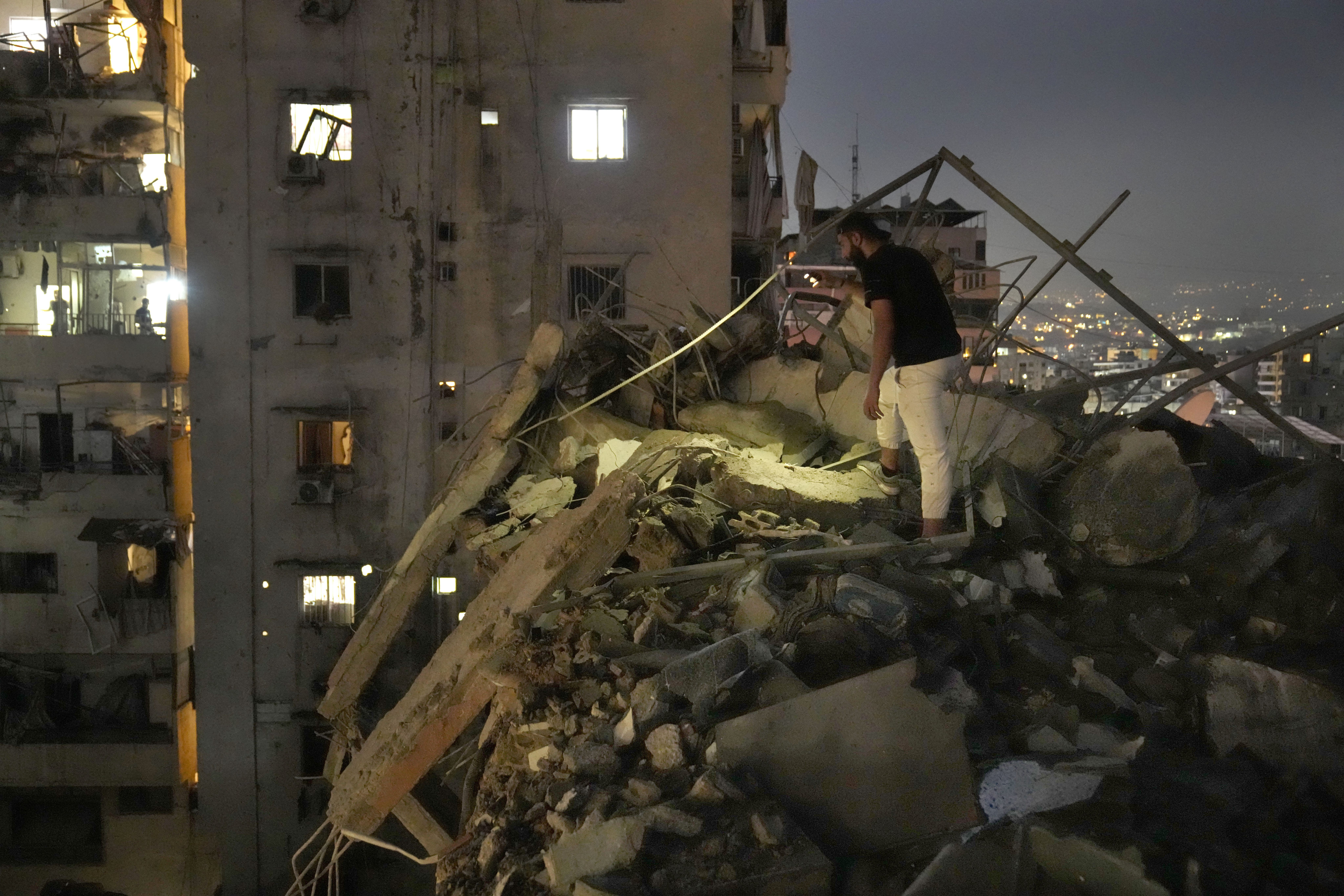 A man inspects a destroyed building that was hit by an Israeli airstrike in the southern suburbs of Beirut, Lebanon on Tuesday. Photo: AP