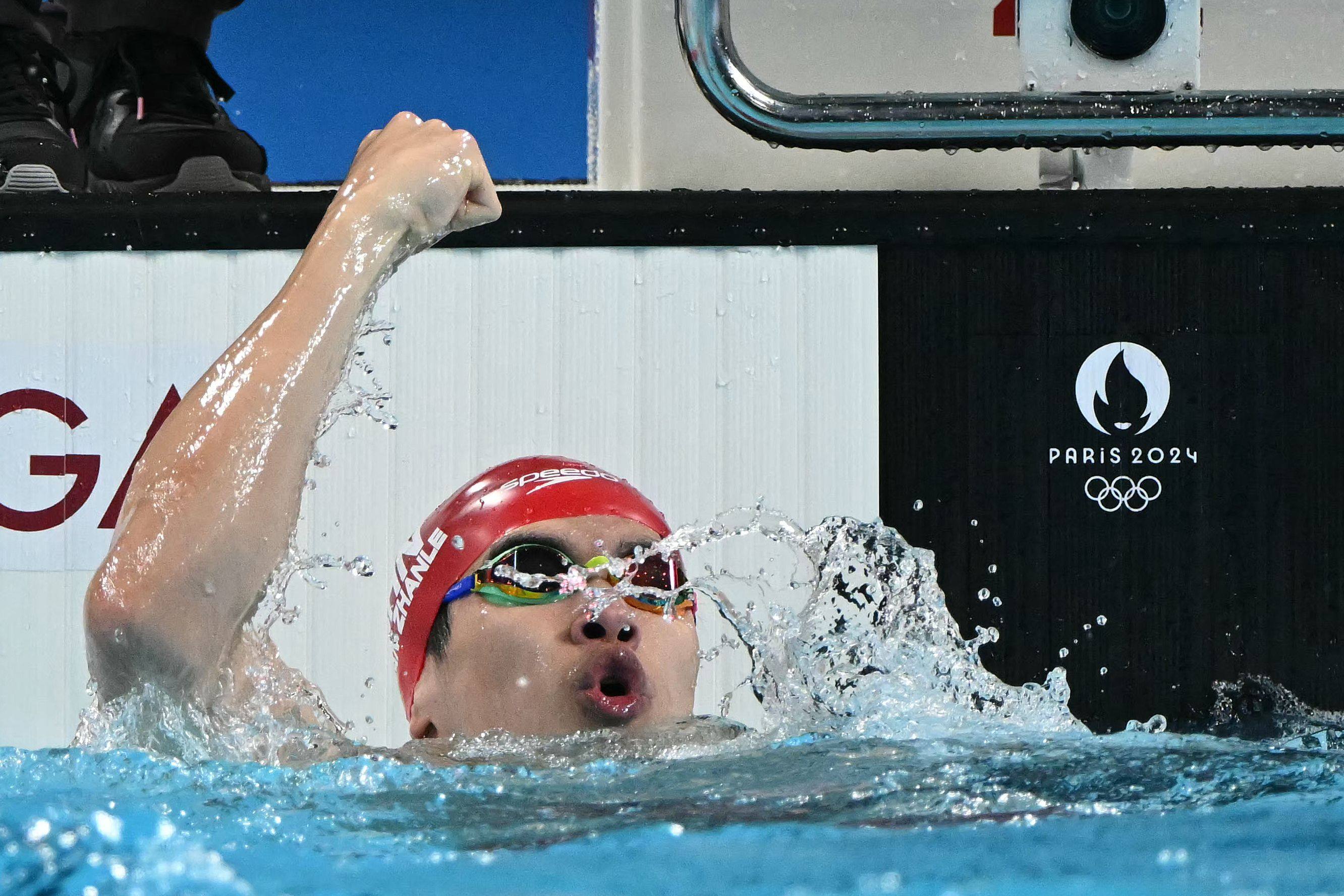 China’s Pan Zhanle raises a fist after breaking the world record on his way to gold. Photo: AFP