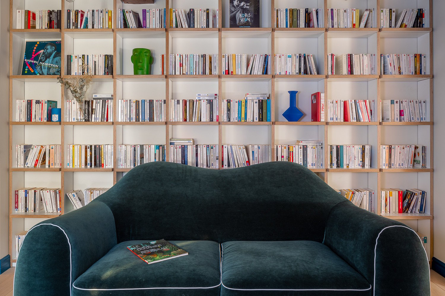 Books and vinyls on wooden shelves in a suite at Chouchou Hôtel in Paris. Photos: Handout