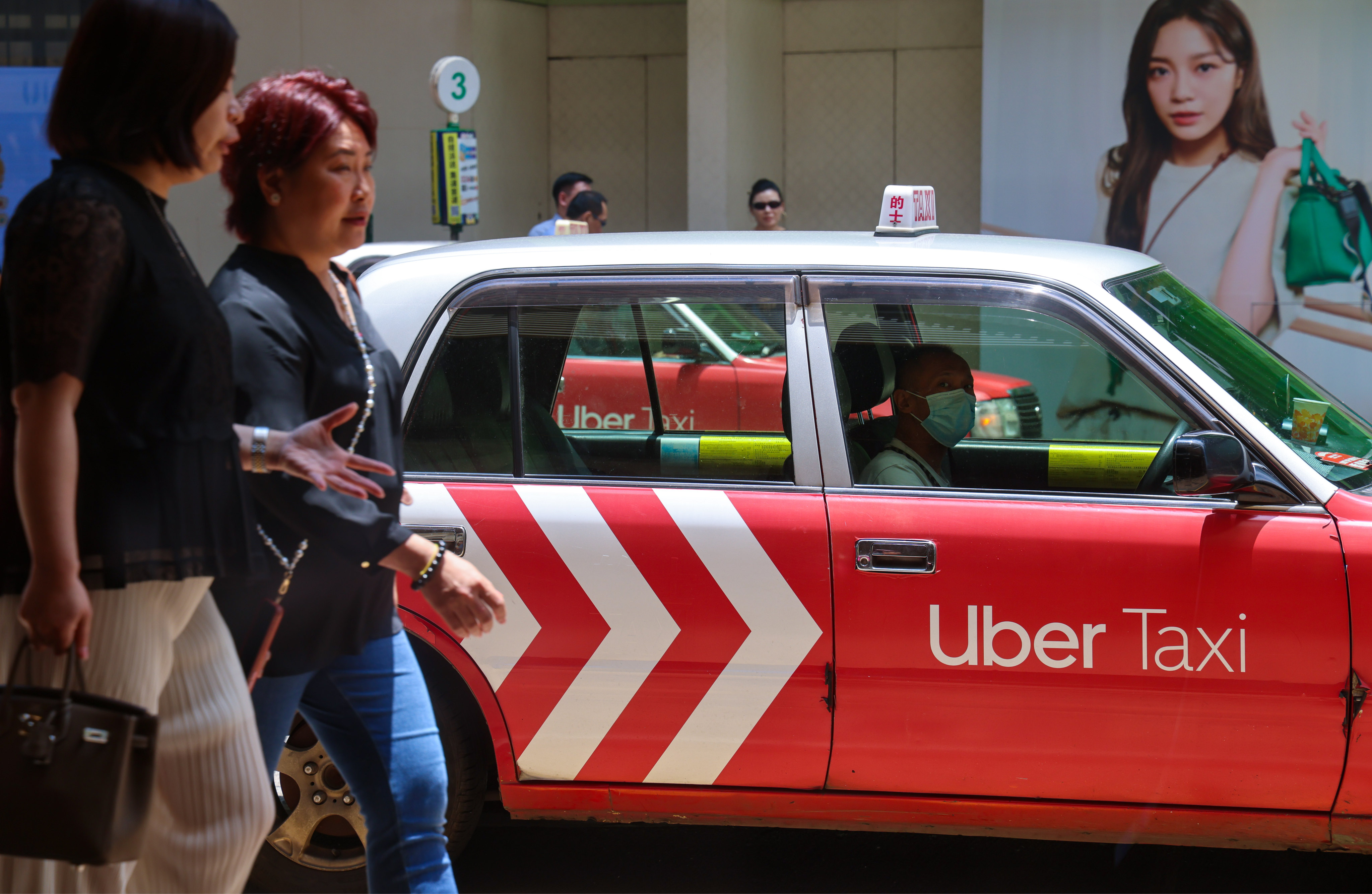 A taxi driver waits for passengers in Tsim Sha Tsui on July 8. Photo: Jelly Tse