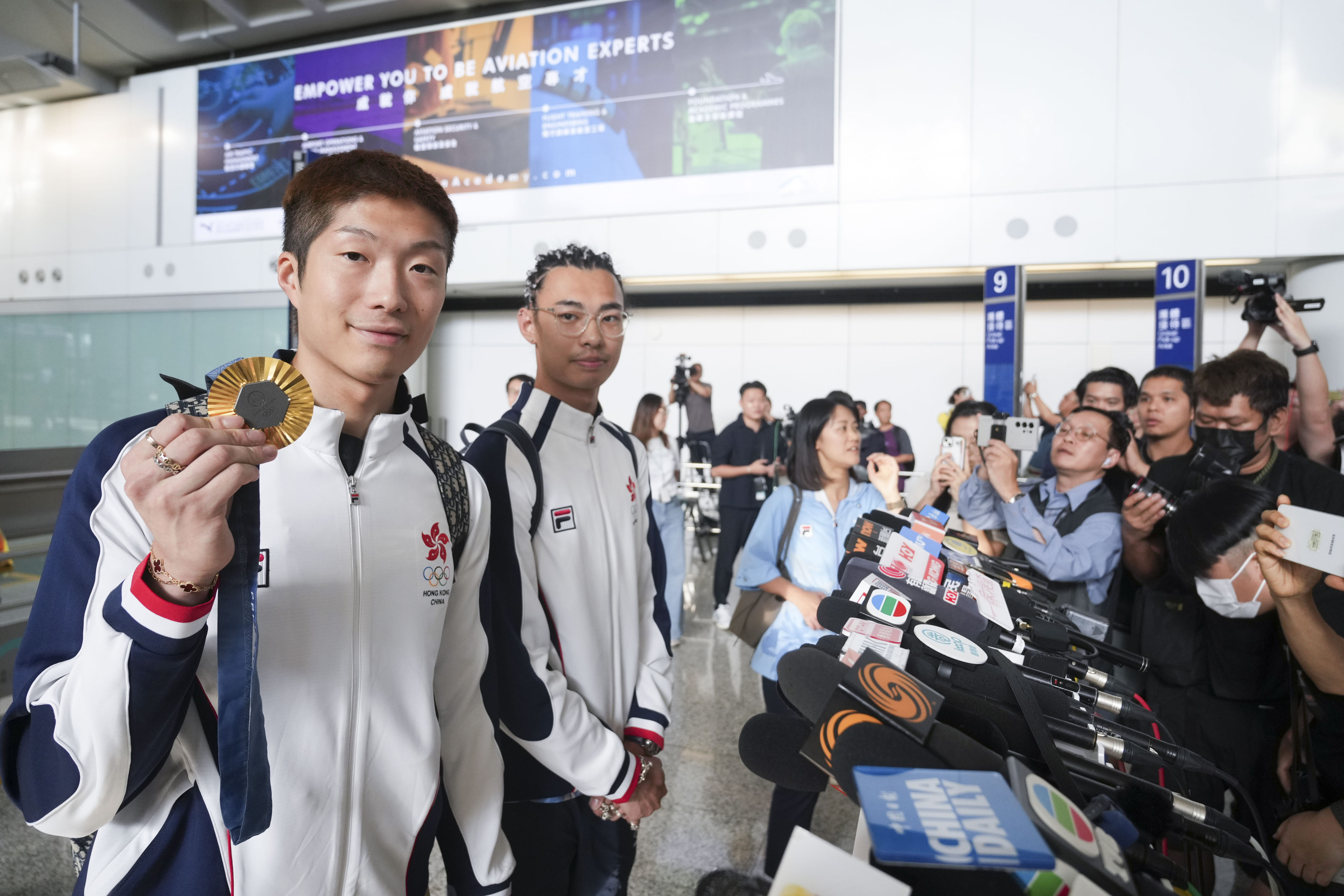 Cheung Ka-long (left) and Cedric Ho were welcomed by about 100 people at Hong Kong International Airport’s arrival hall. Photo: Sam Tsang