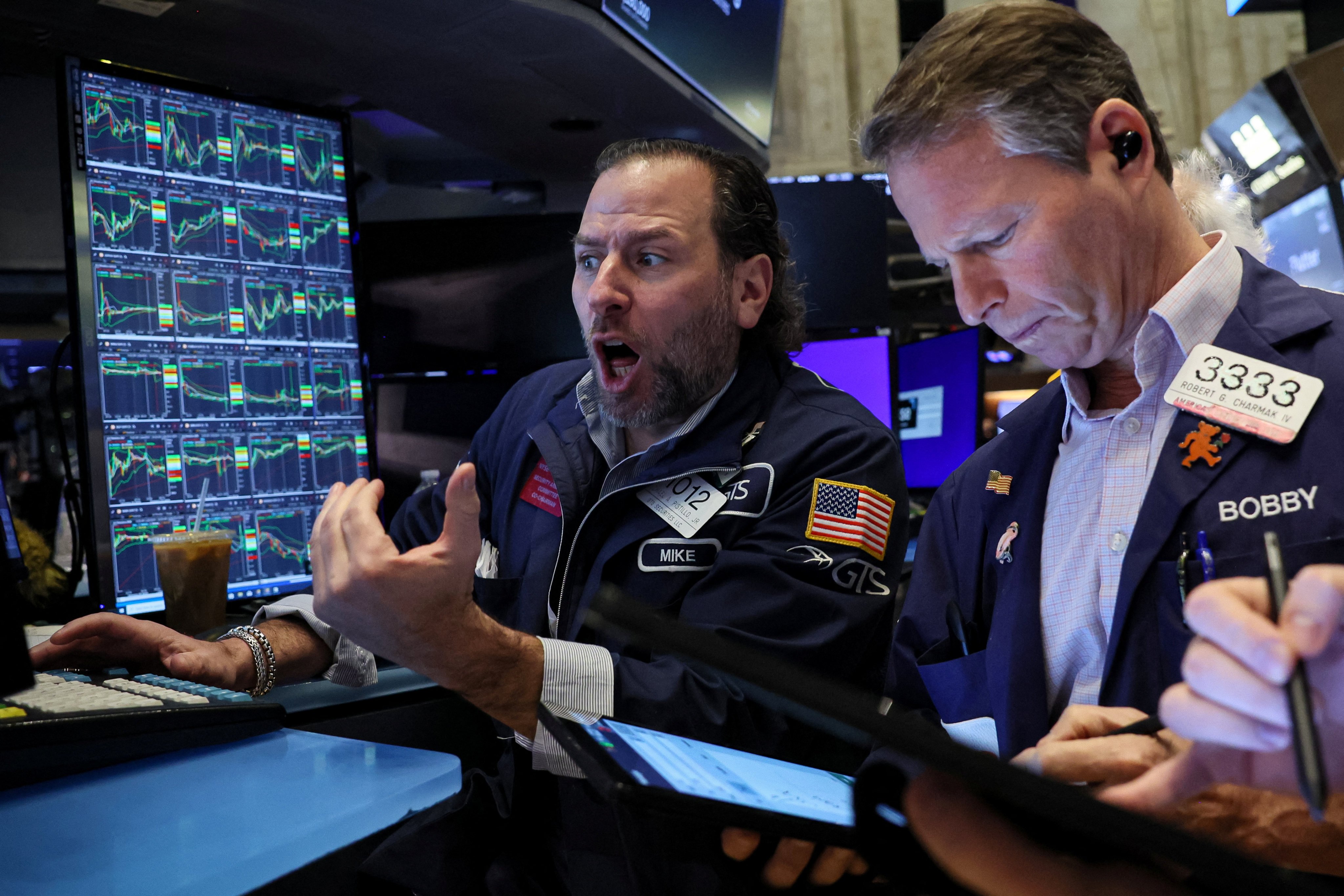 Traders work on the floor of the New York Stock Exchange on January 29. Markets are swinging but the unmistakable trend is downwards. Photo: Reuters