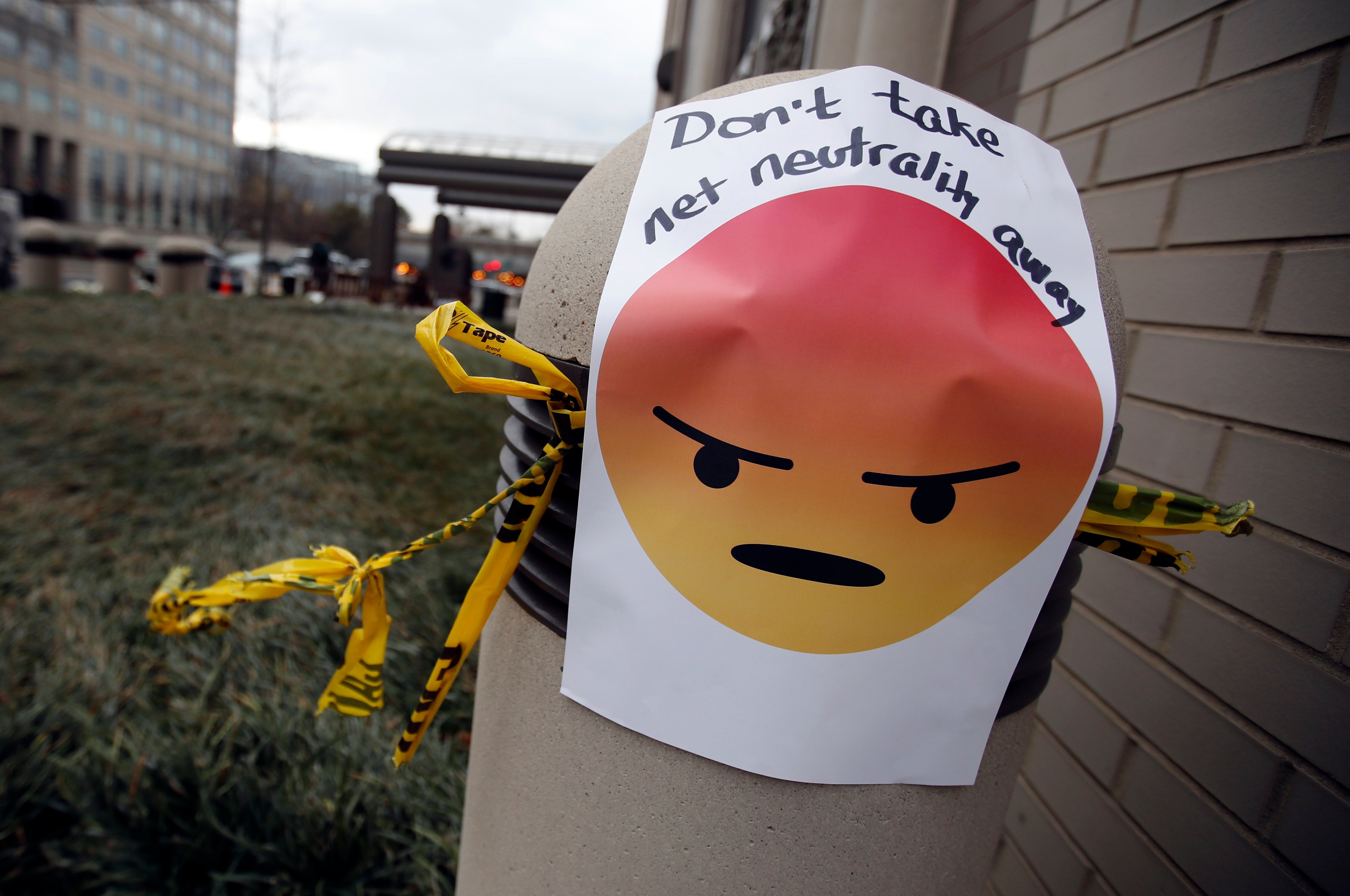 A sign with an emoji reading “Don’t take net neutrality away”. Photo: AP