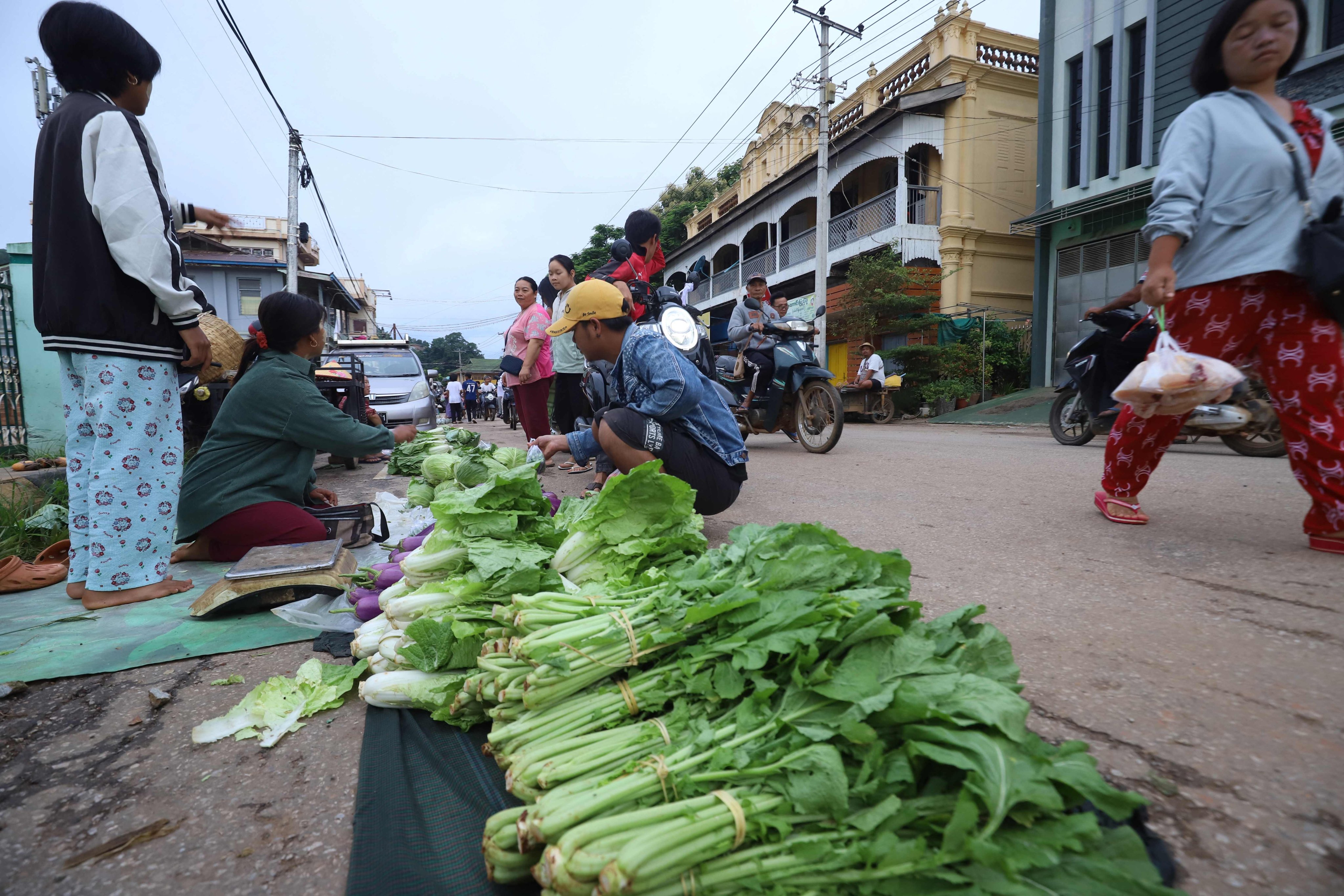 Vendors selling vegetables at a street market in Kyaukme in Myanmar’s northern Shan State earlier this month. Photo: AFP