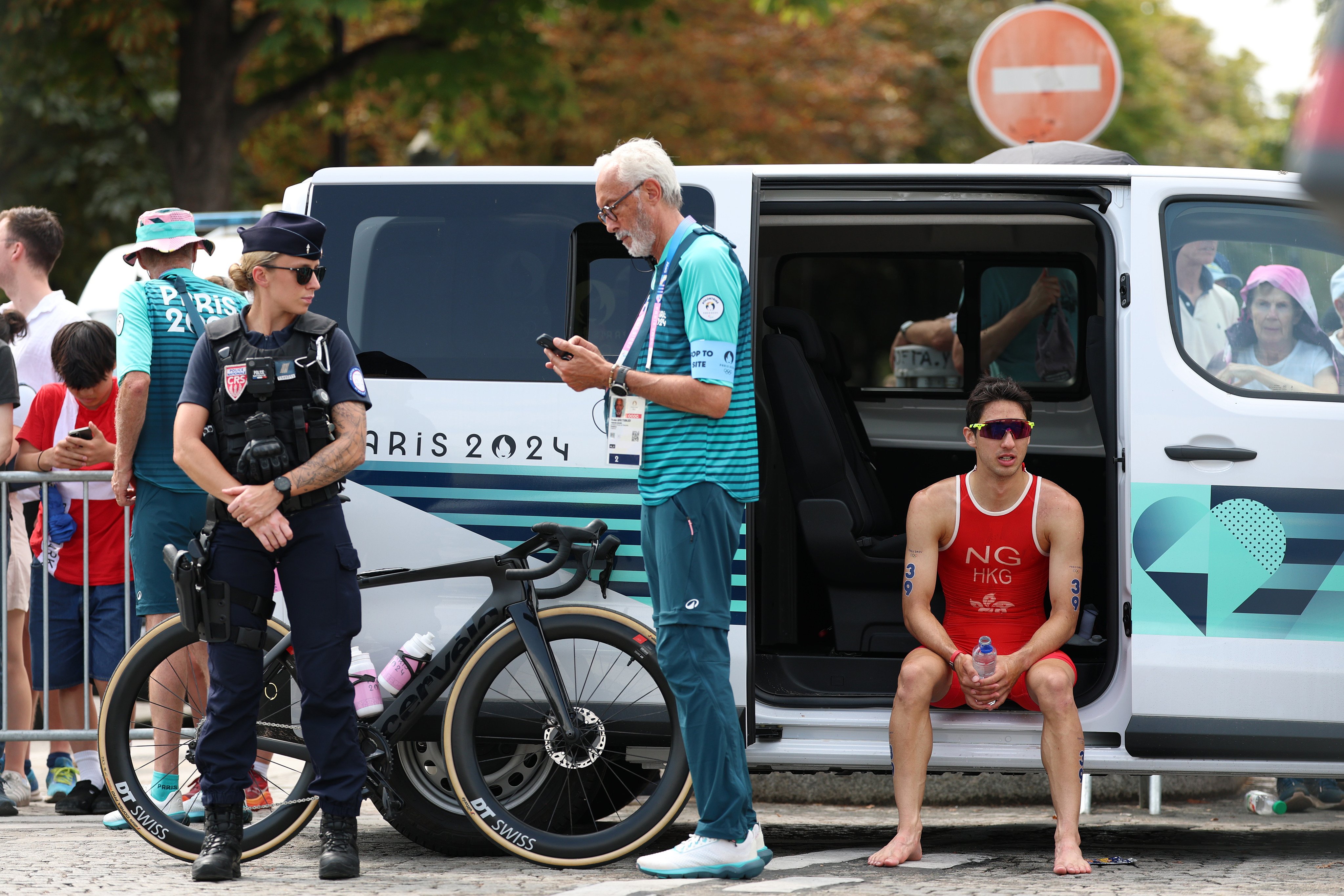 Hong Kong’s Jason Ng sits in a van after withdrawing during the men’s individual triathlon at the Paris Olympics. Photo: Xinhua