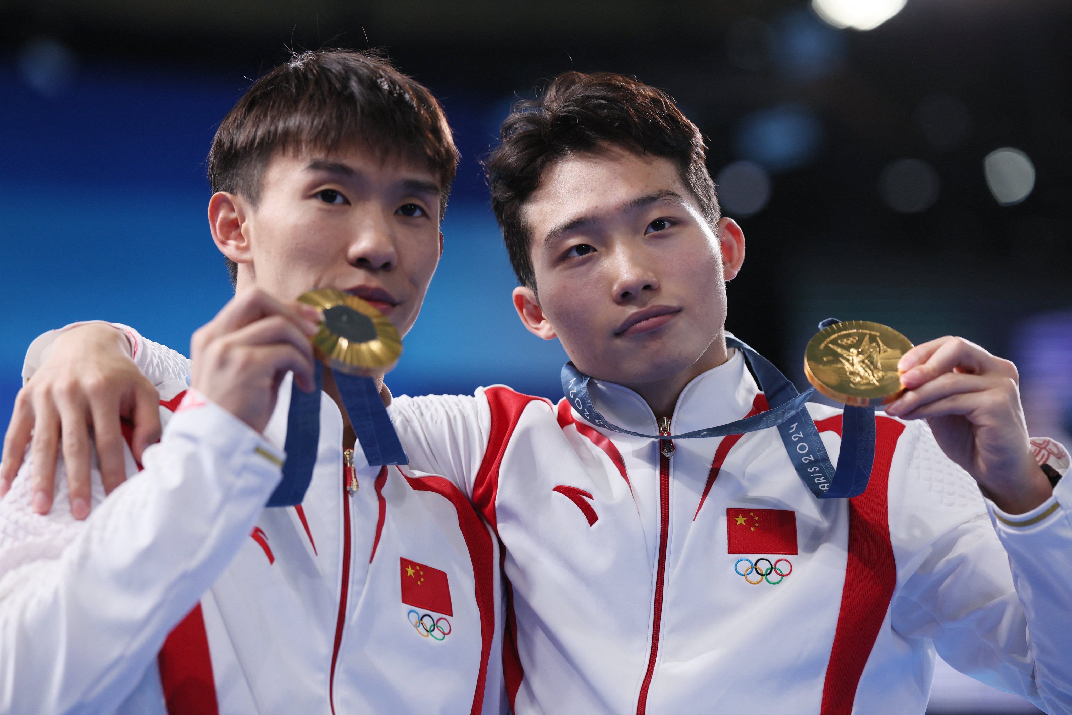 Gold medallists Long Daoyi and Wang Zongyuan pose with their medals. Photo: Reuters