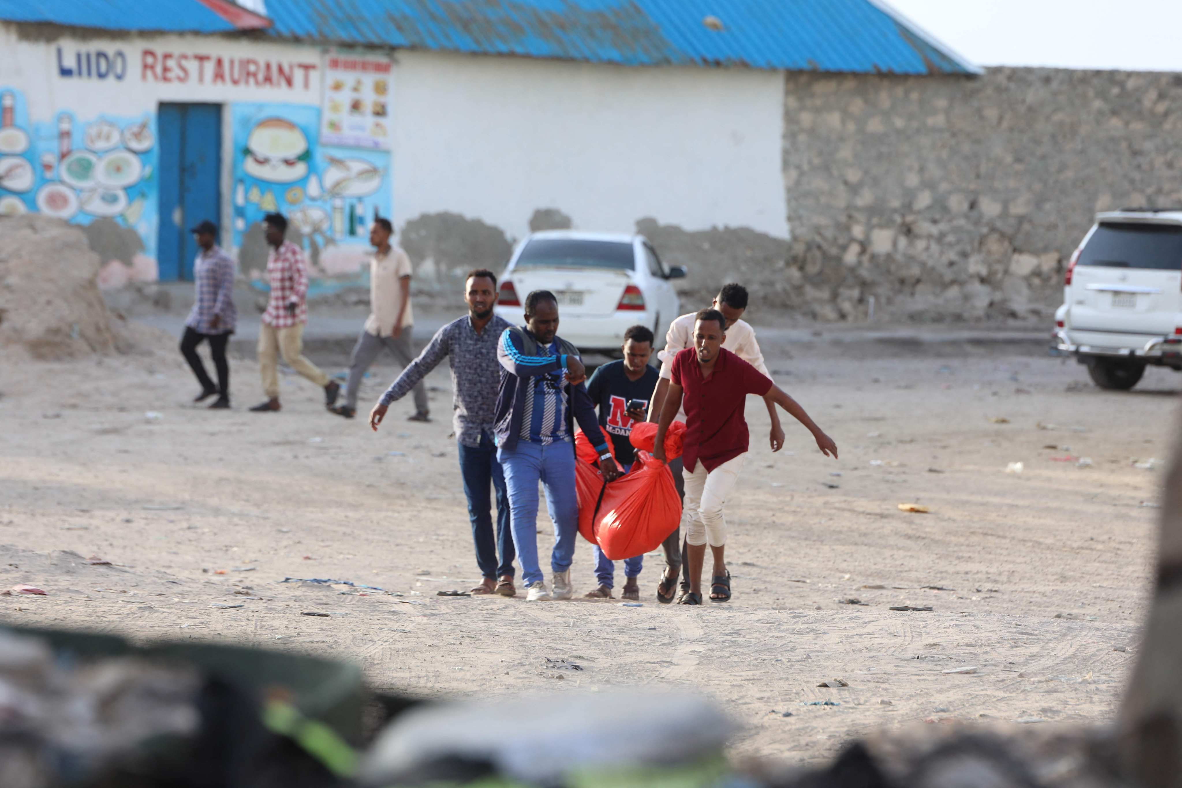 Relatives carry the body of a woman killed during an Al-Shabaab attack in Mogadishu on Saturday. Photo: AFP