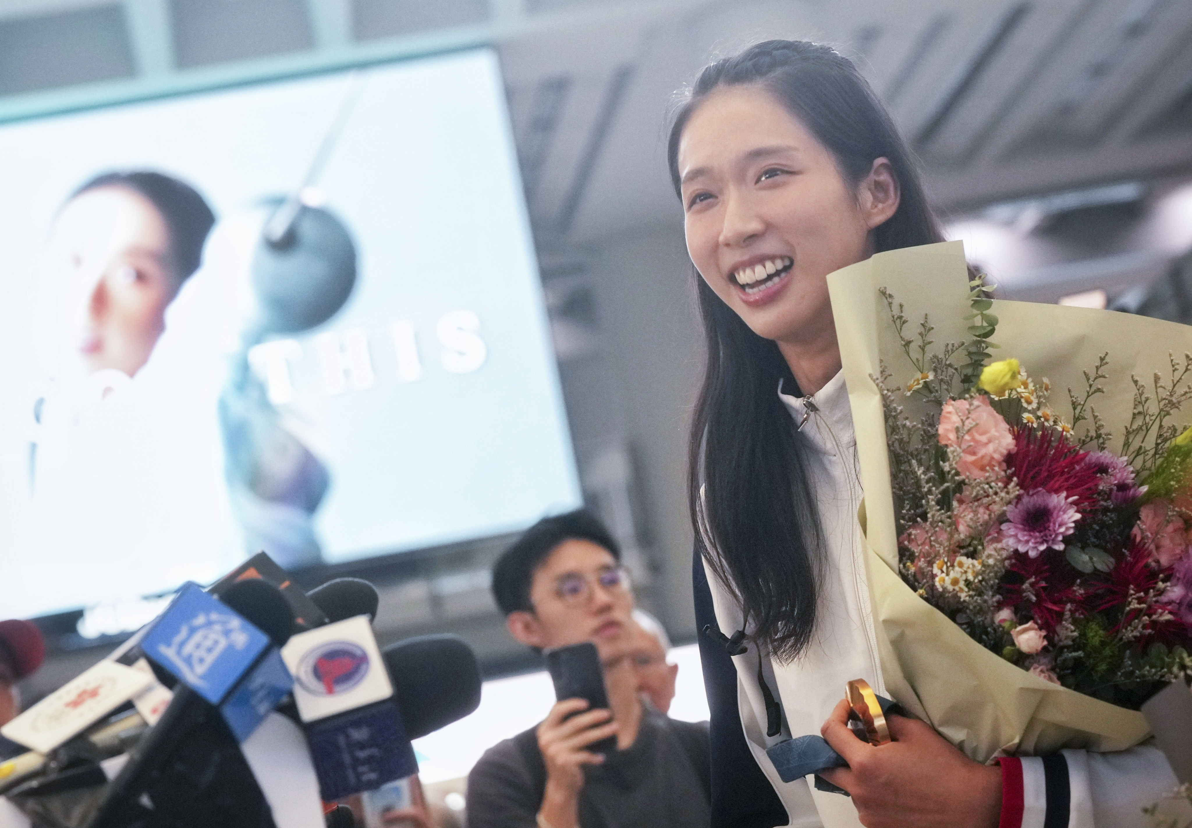 Olympic gold medalist Vivian Kong meets the press at Hong Kong International Airport after returning from Paris. Photo: Elson Li