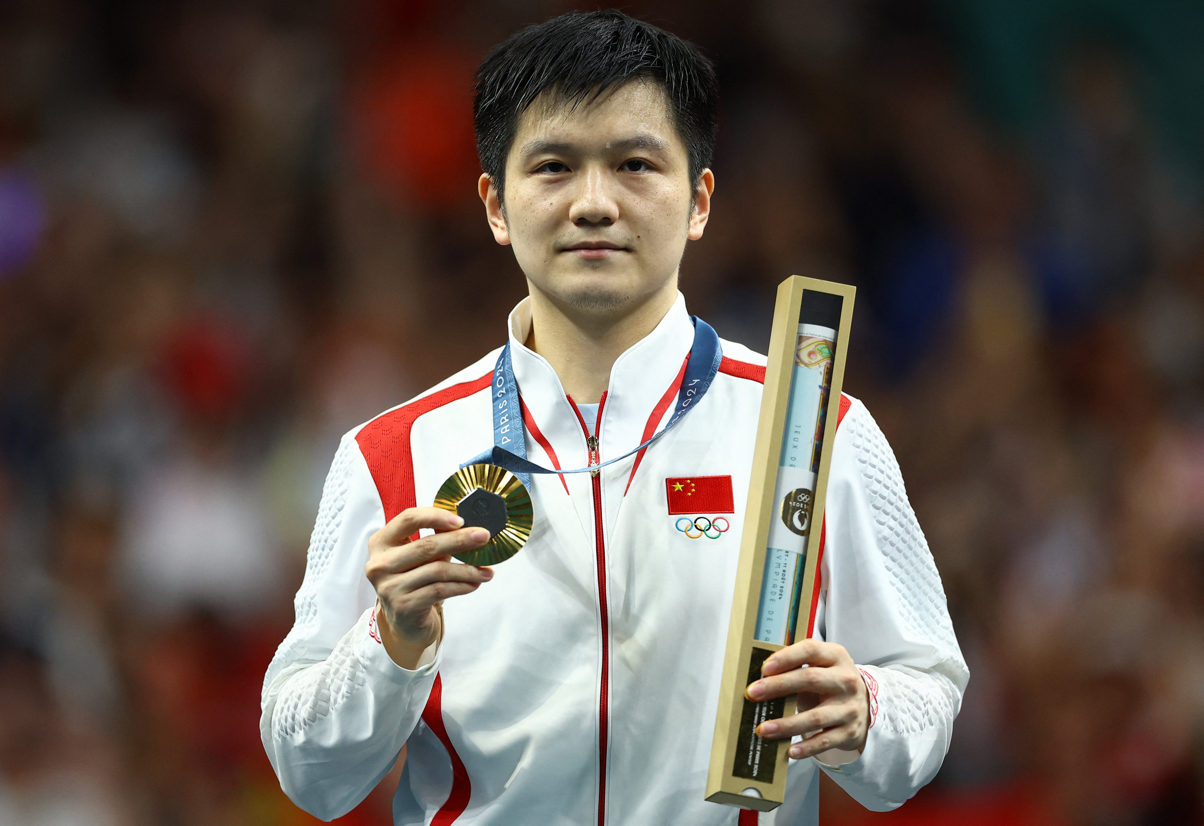 China’s Fan Zhendong poses with his gold medal. Photo: Reuters