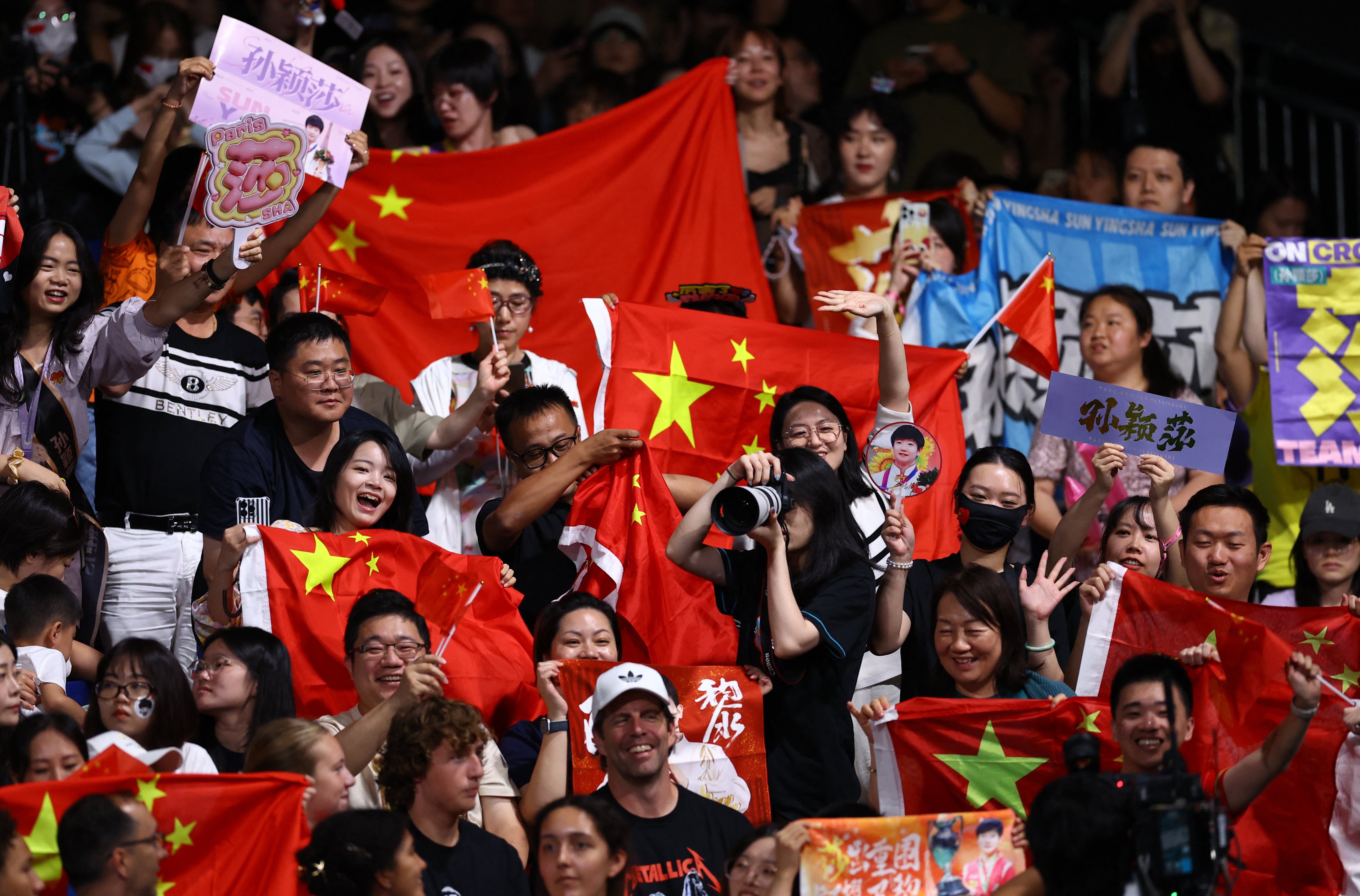 Chinese fans display signs backing Sun Yingsha during the table tennis women’s singles final. Photo: Reuters