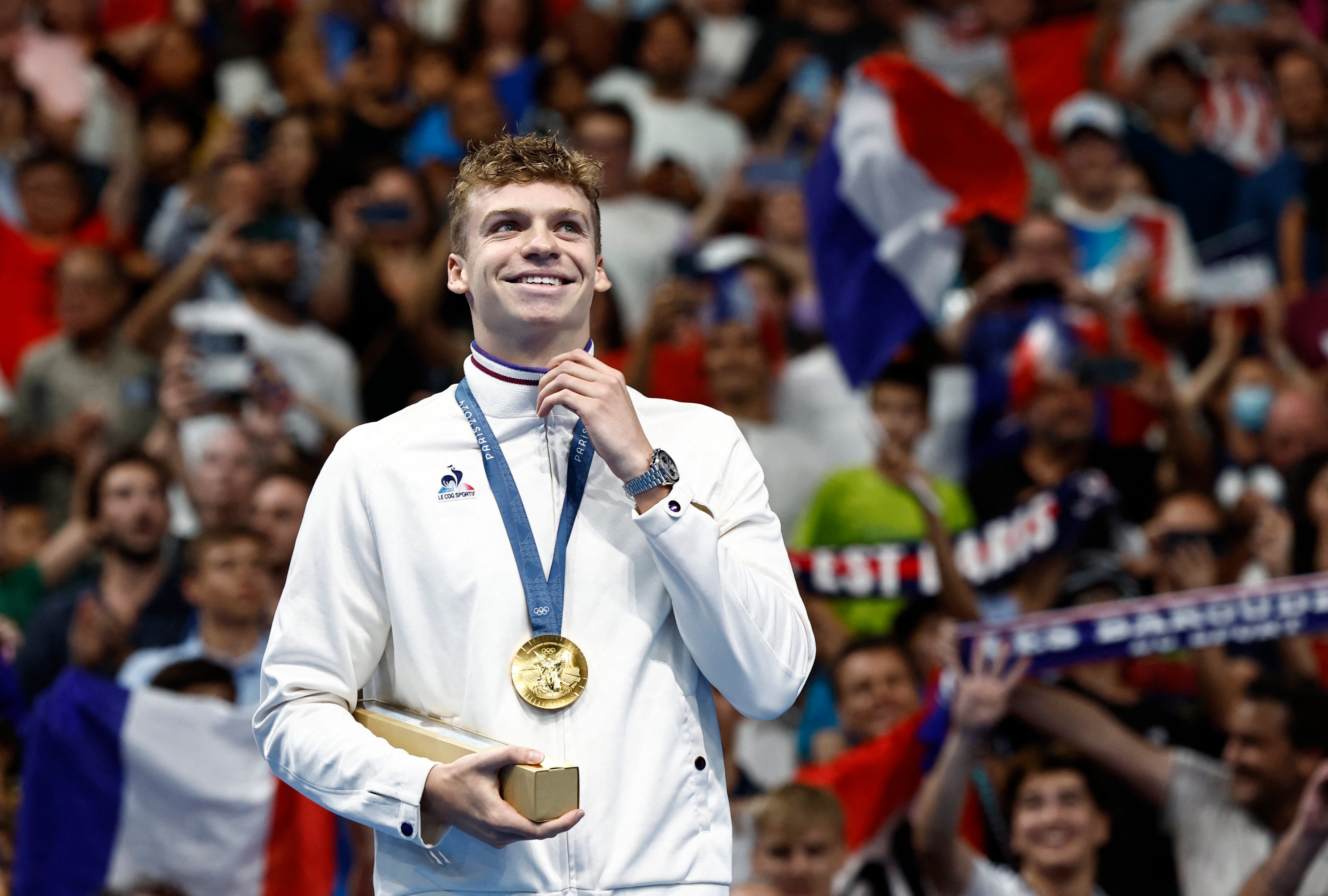 Leon Marchand of France collects gold for the 200 metres individual medley. Photo: Reuters