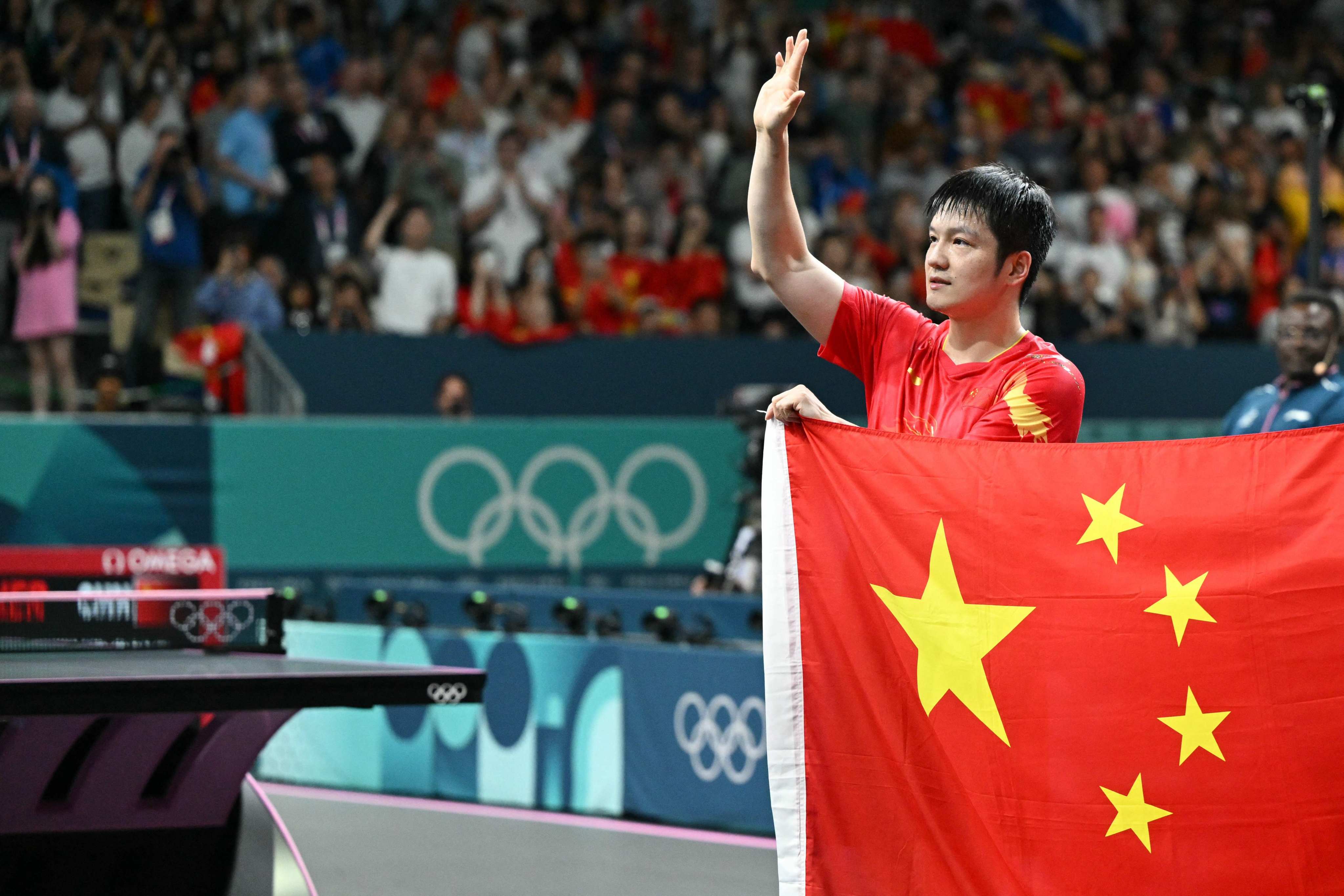 China’s Fan Zhendong celebrates after winning the men’s table tennis singles gold medal match against Sweden’s Truls Moregard. Photo: AFP