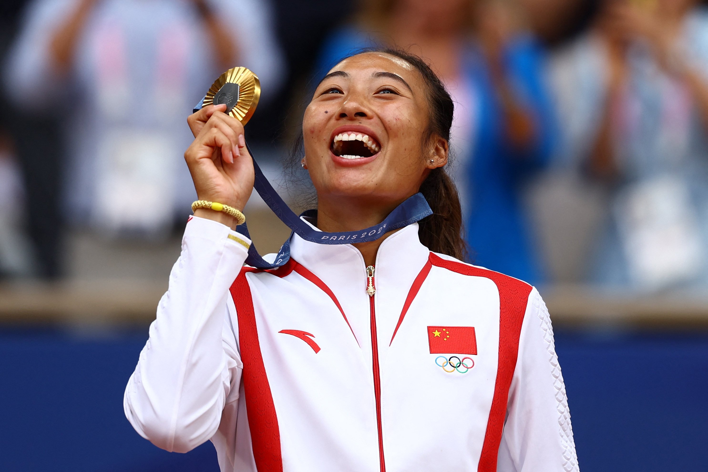 Gold medallist Qinwen Zheng of China poses with her medal. Photo: Reuters