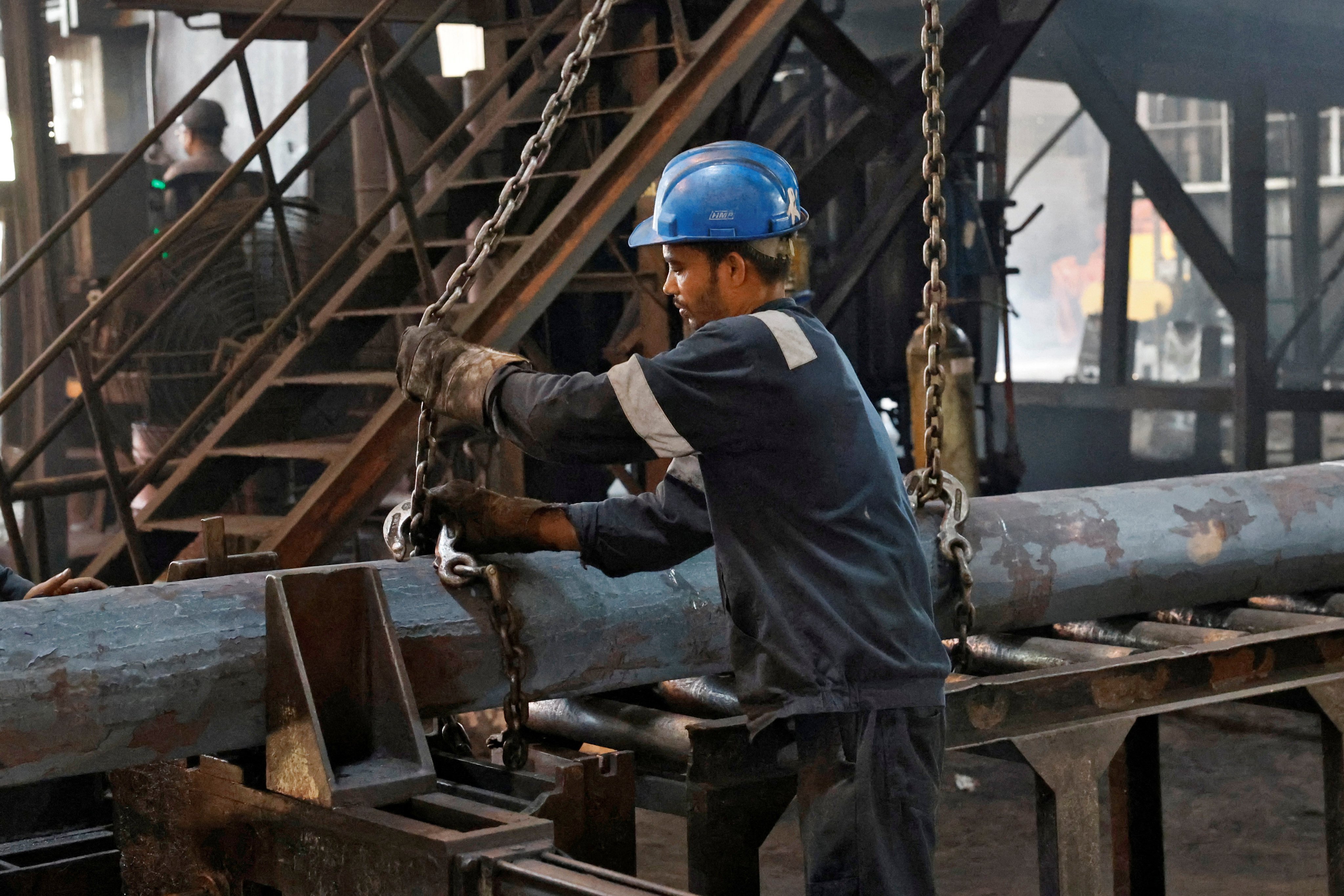 An employee prepares to move a steel bar in the ArcVac ForgeCast factory in West Bengal, India, on April 26. Many producers are shifting to electric arc furnaces, which can use up to 100 per cent scrap metal, unlike traditional blast furnaces. Photo: Reuters