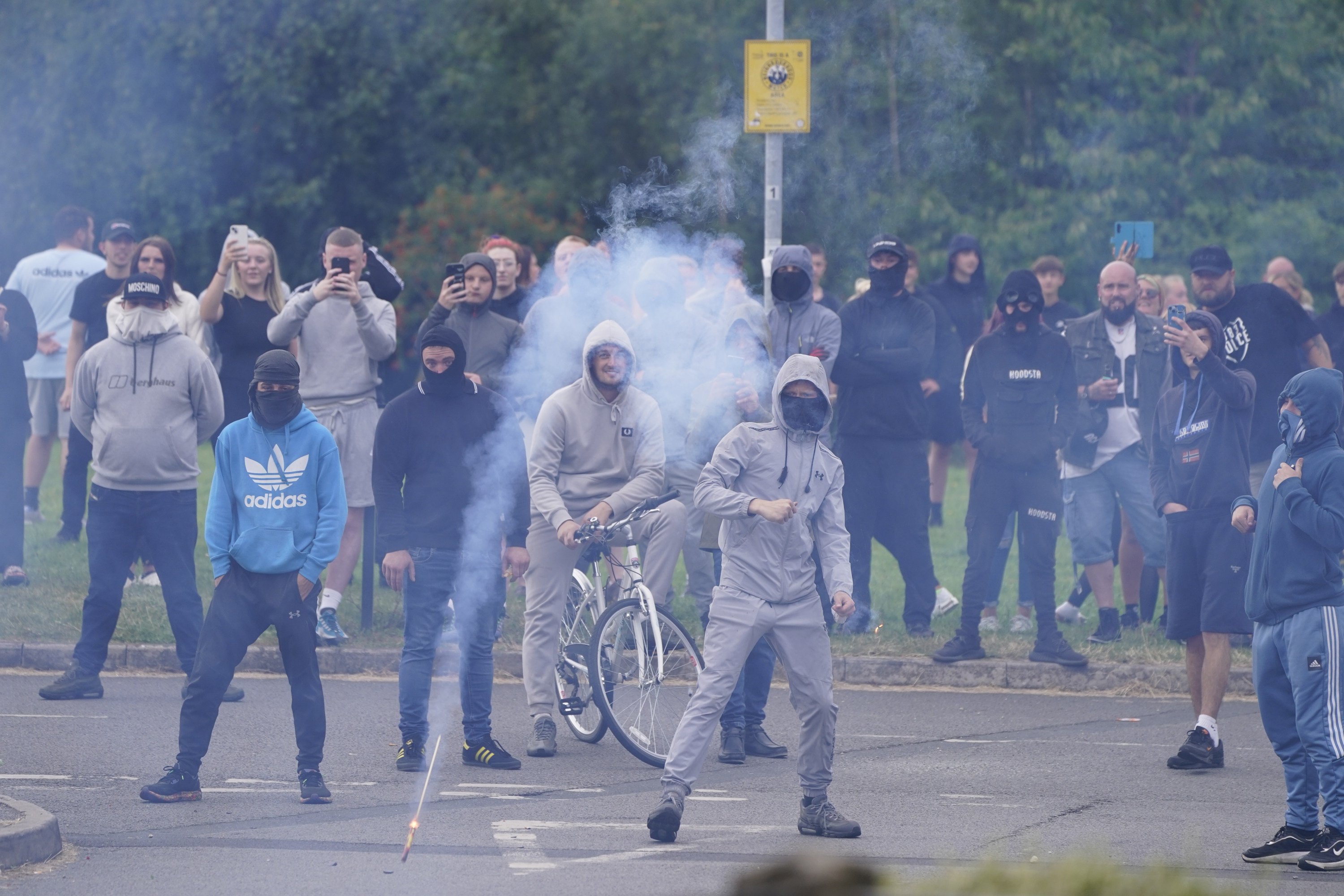 Fireworks are thrown towards police during an anti-immigration demonstration in Rotherham, South Yorkshire, England, on Sunday. Photo: dpa