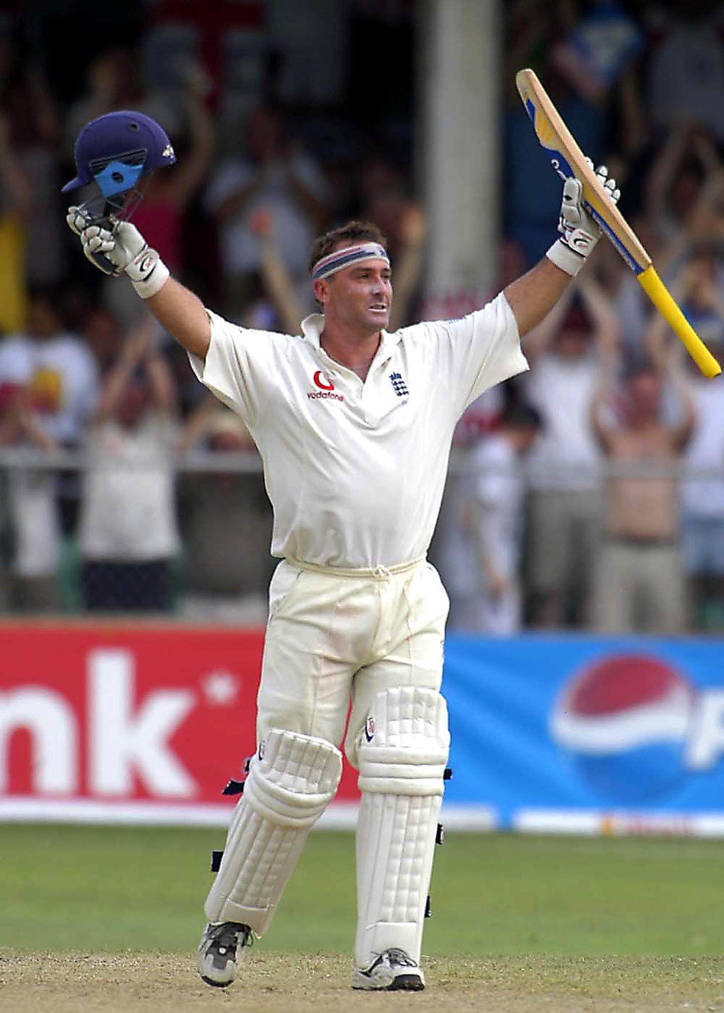 England’s batsman Graham Thorpe raises his bat and helmet in celebration after scoring an unbeaten 119 on the second day of the third Test against West Indies at Kensington Oval, Barbados, April 2, 2004. Photo: AP